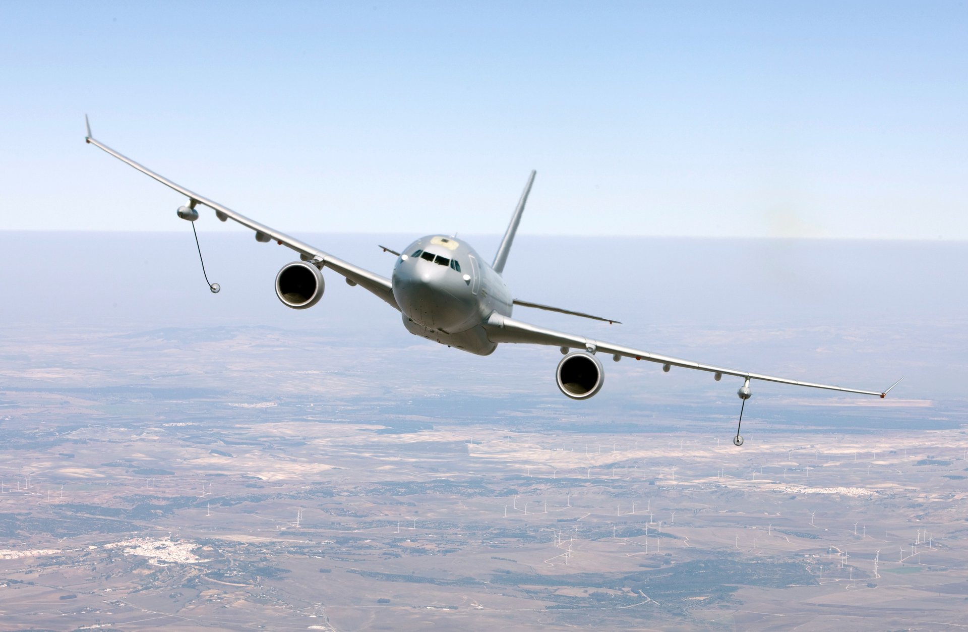 A helicopter and airplane fly in the sky.