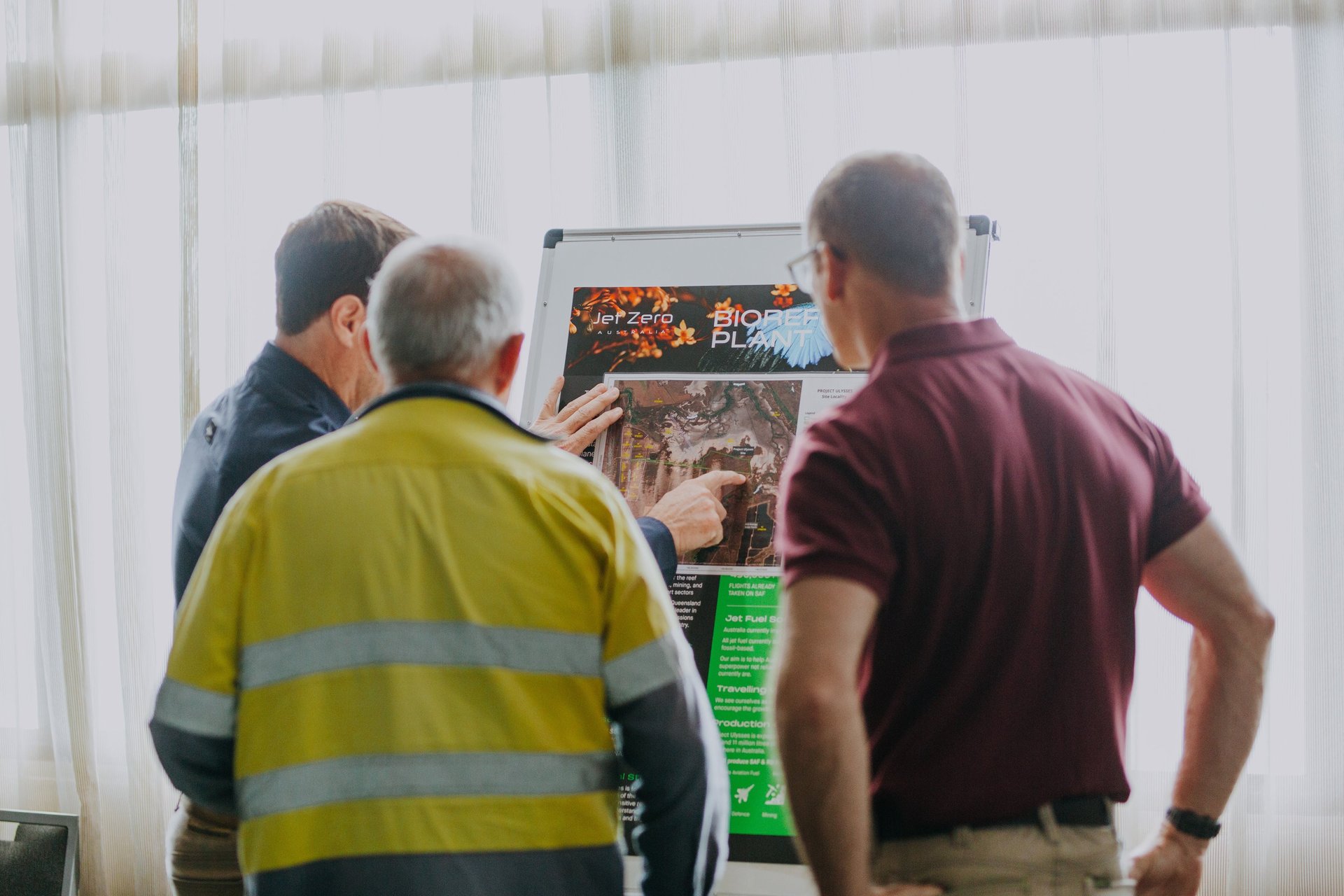 brown cattle on green field surrounded with green trees under white and blue sky