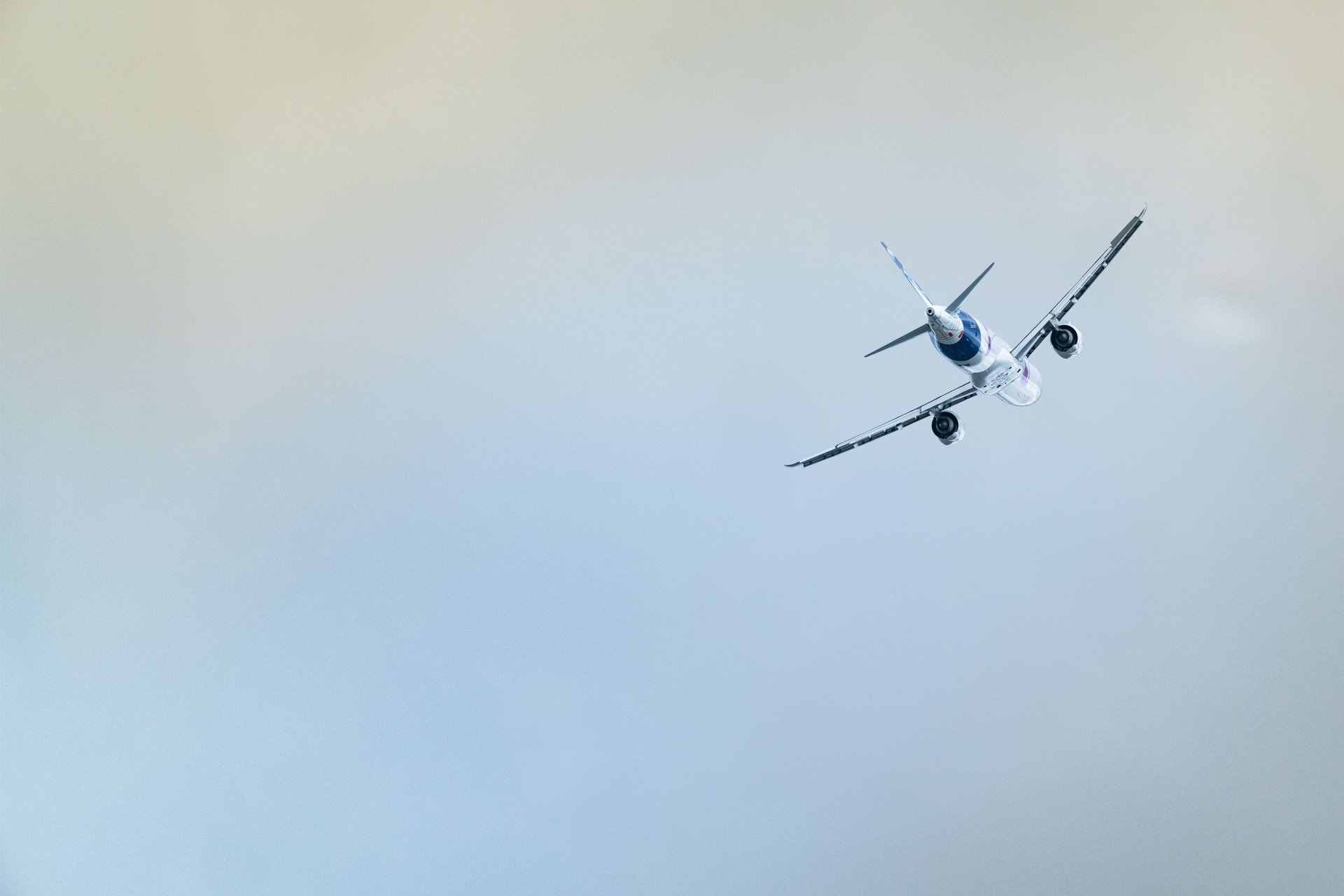 A helicopter and airplane fly in the sky.