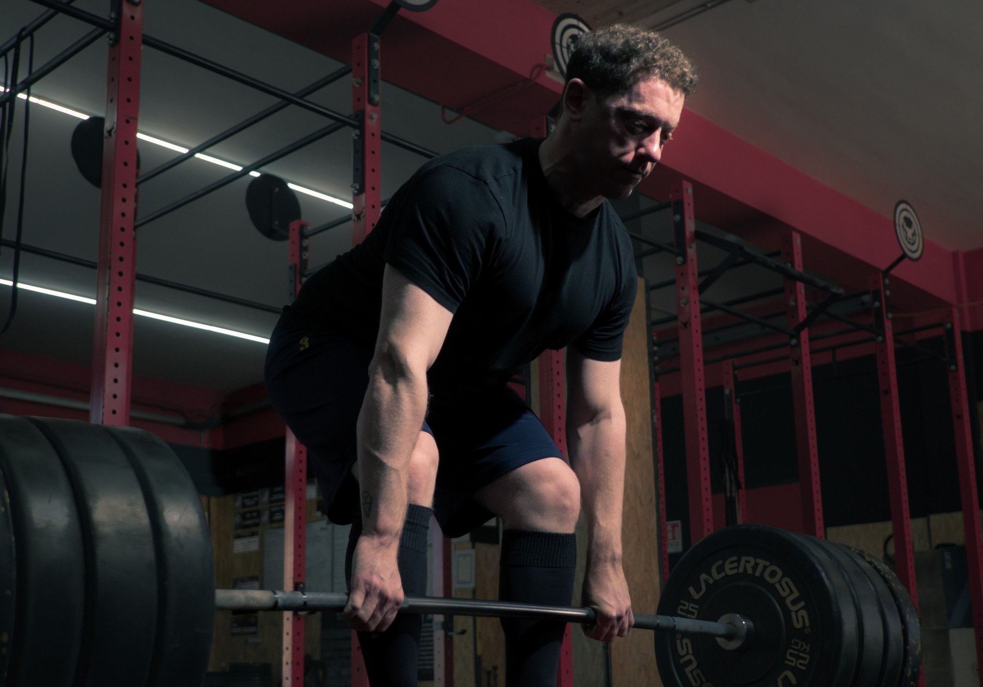 black barbell on tile flooring