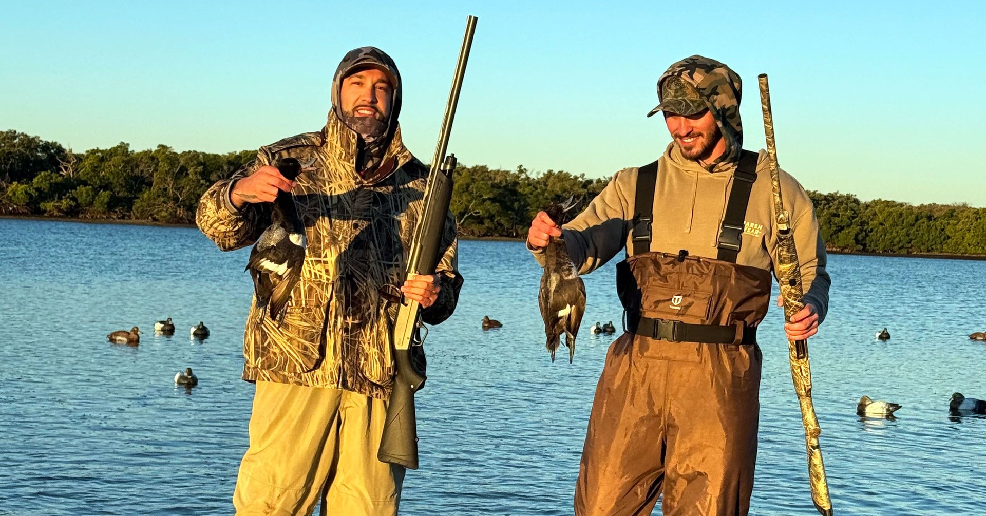 mallard duck flying over the sea during daytime