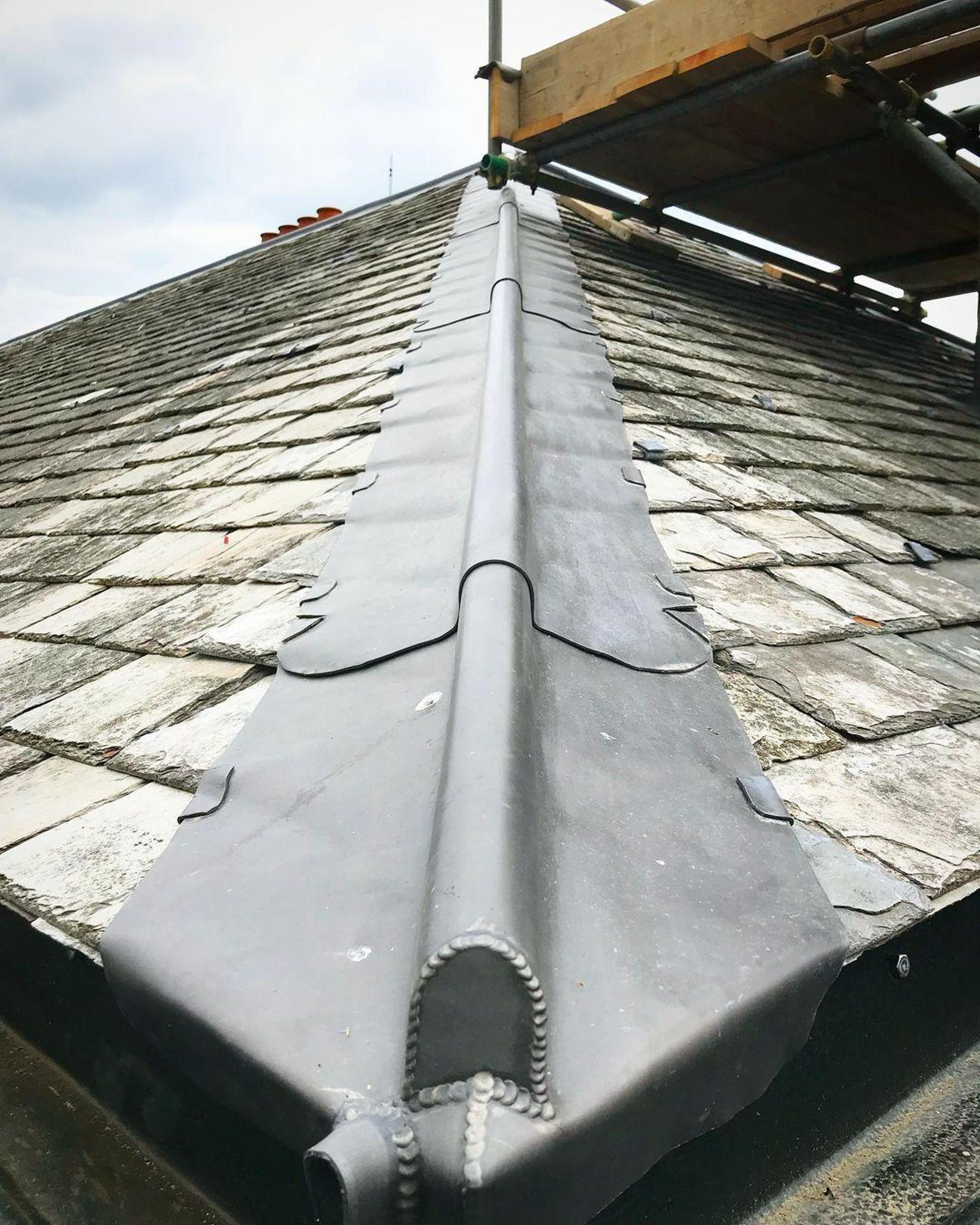 a person wearing blue gloves and holding a hammer