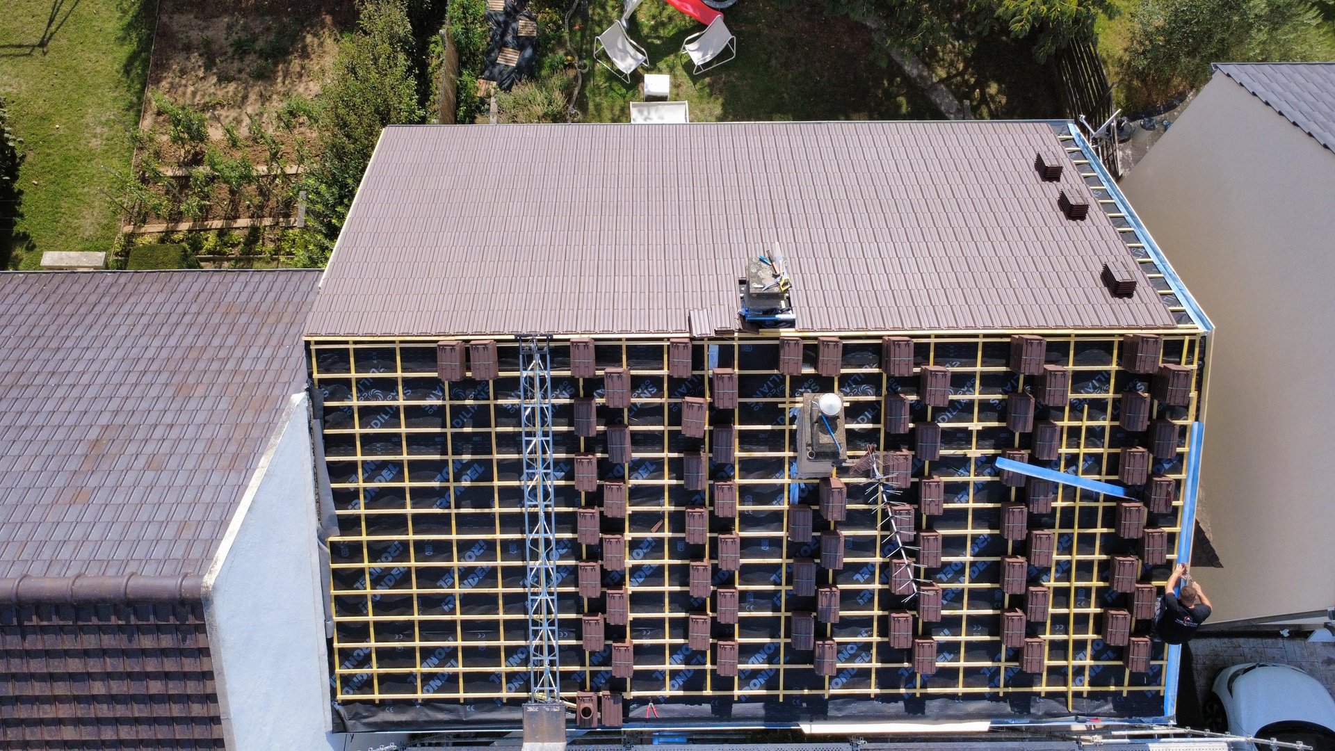 a person wearing blue gloves and holding a hammer