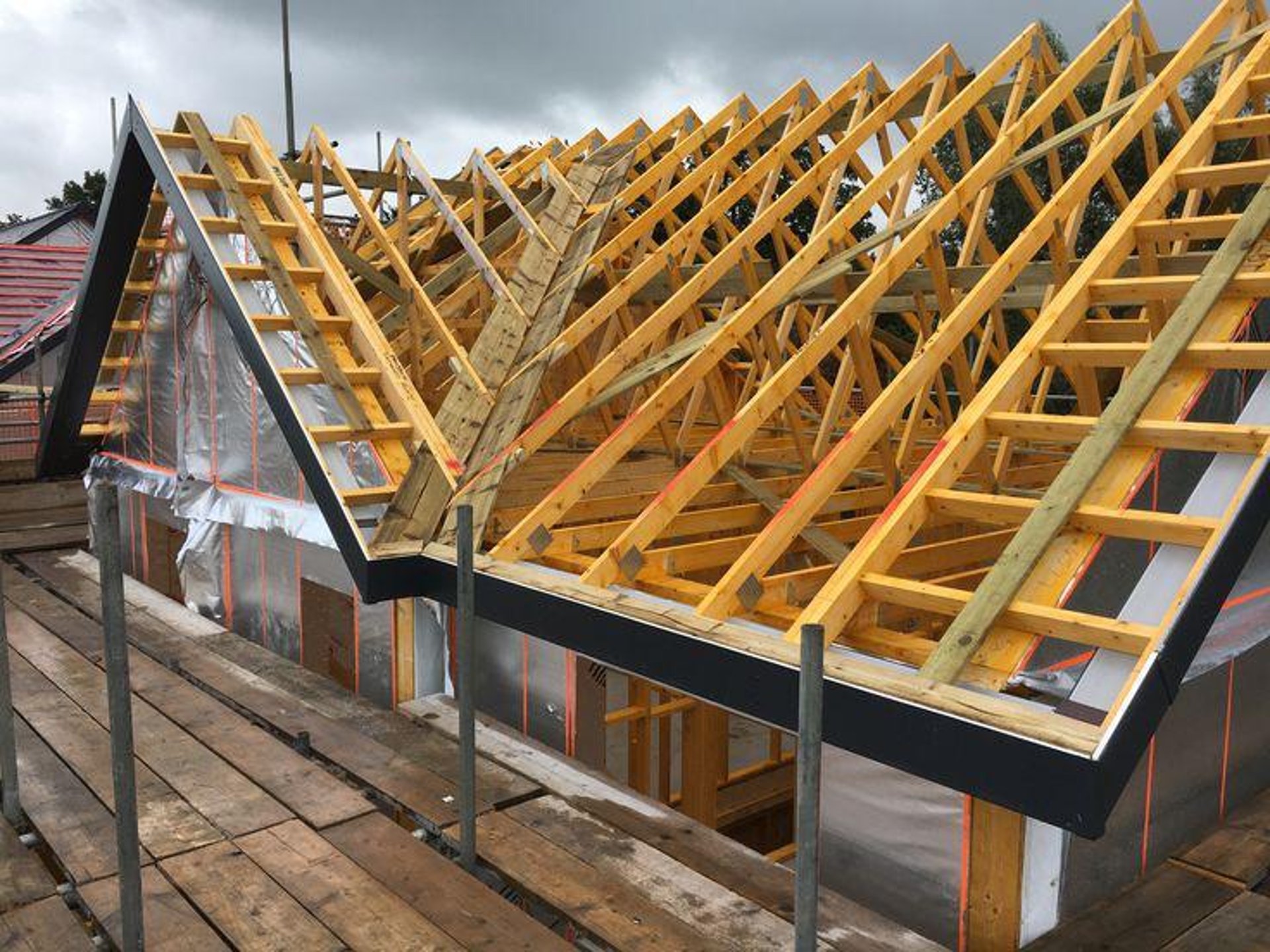 person in blue pants sitting on brown wooden floor