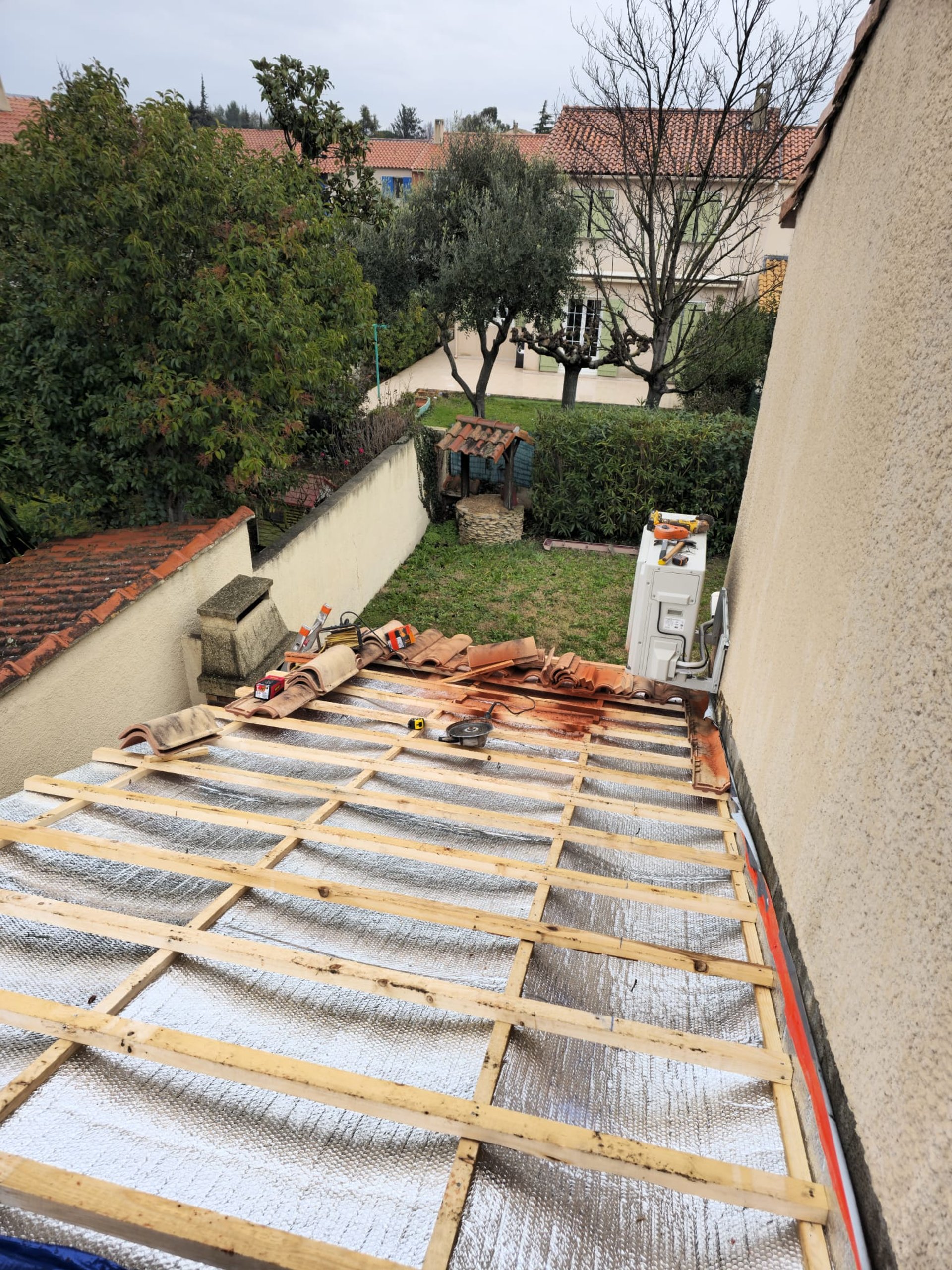 person in blue pants sitting on brown wooden floor
