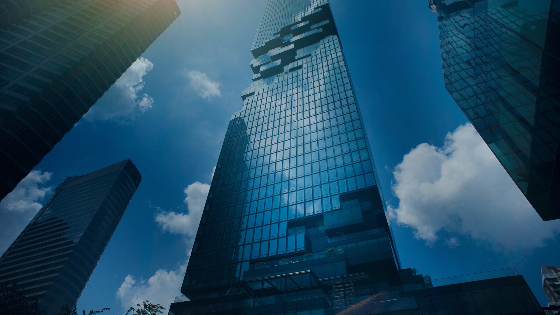 an abstract photo of a curved building with a blue sky in the background