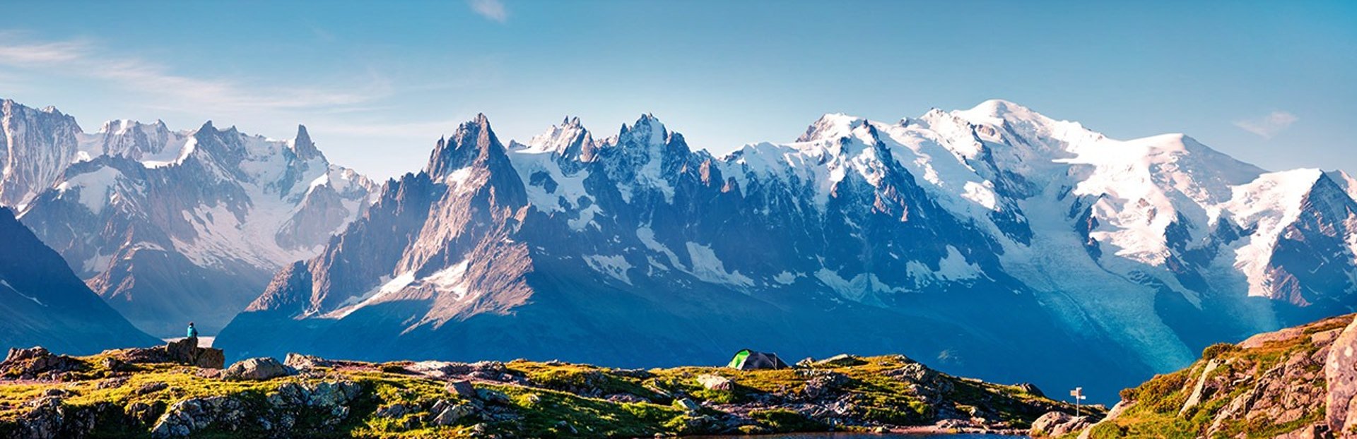 woman in white vest and black bikini with hand on chest