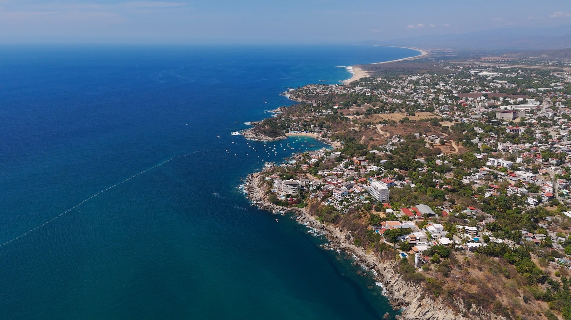 an abstract photo of a curved building with a blue sky in the background