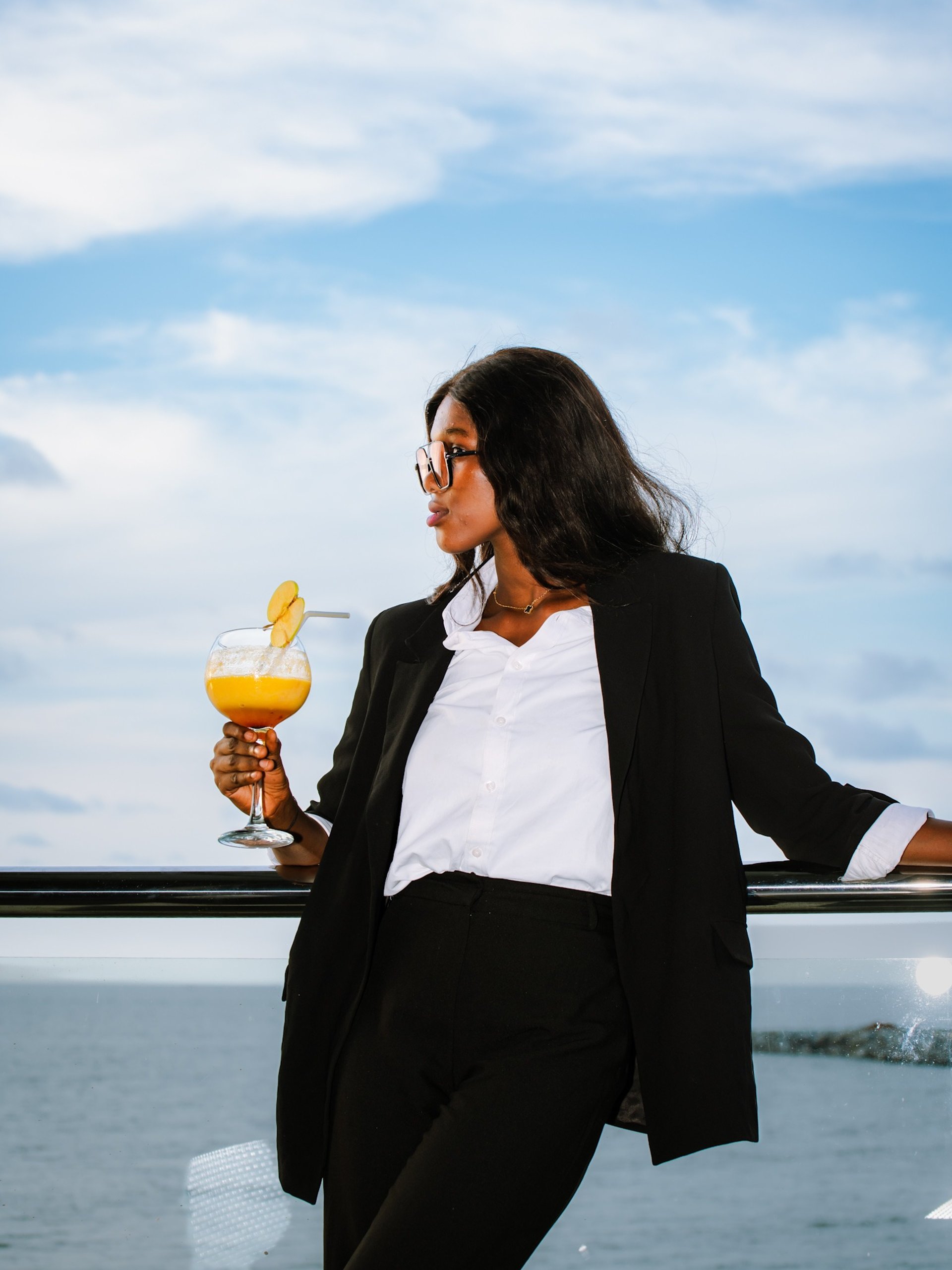woman wearing yellow long-sleeved dress under white clouds and blue sky during daytime