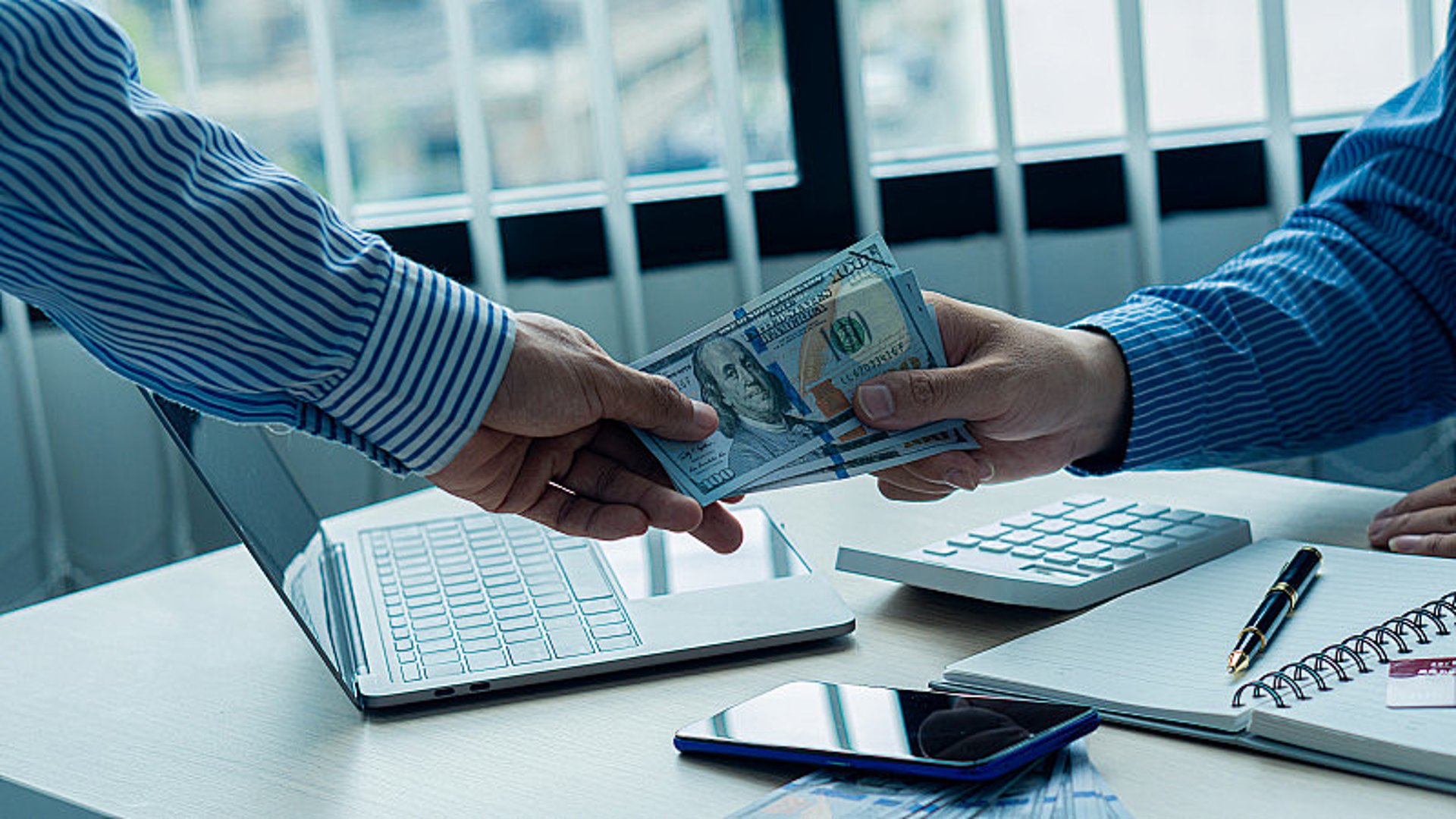 an abstract photo of a curved building with a blue sky in the background