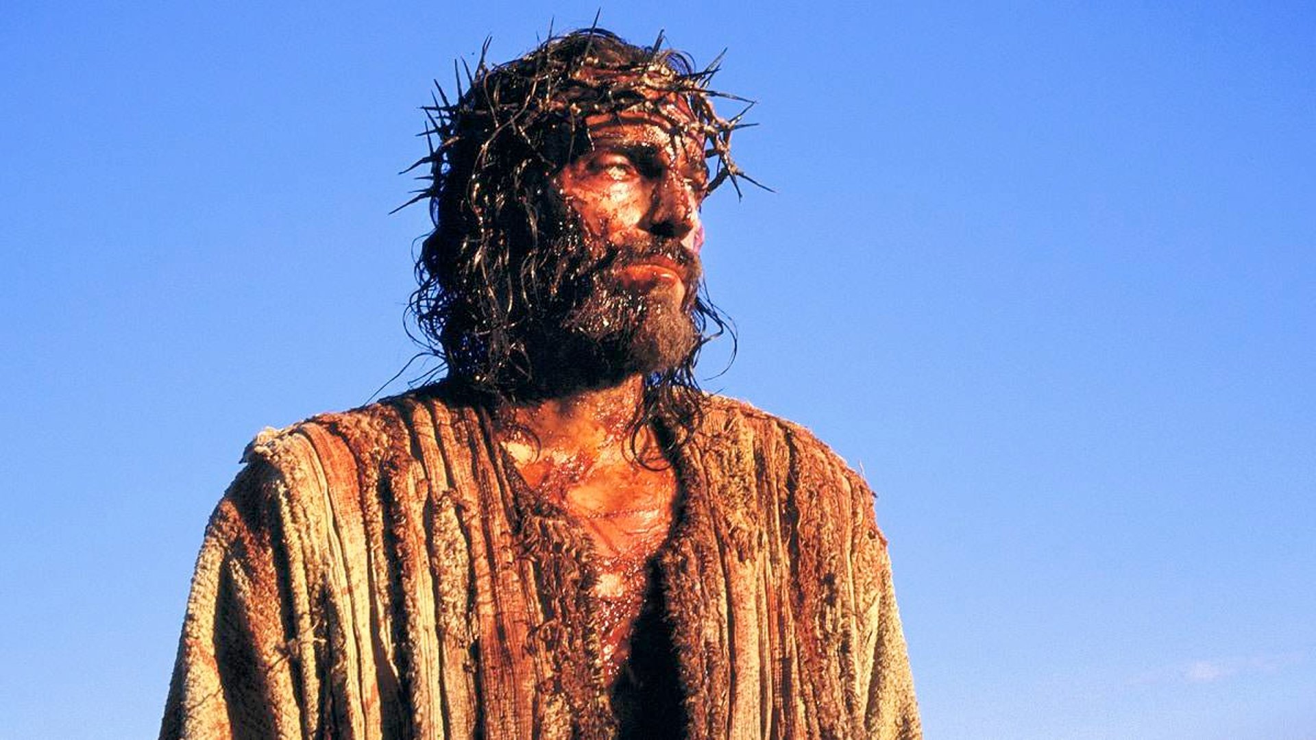 an abstract photo of a curved building with a blue sky in the background