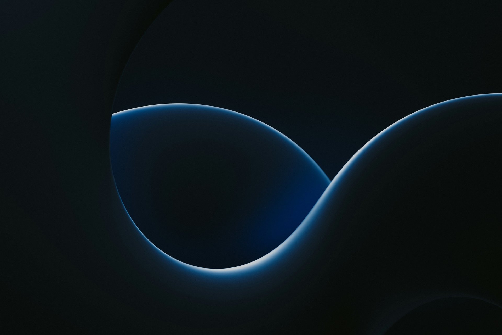 an abstract photo of a curved building with a blue sky in the background