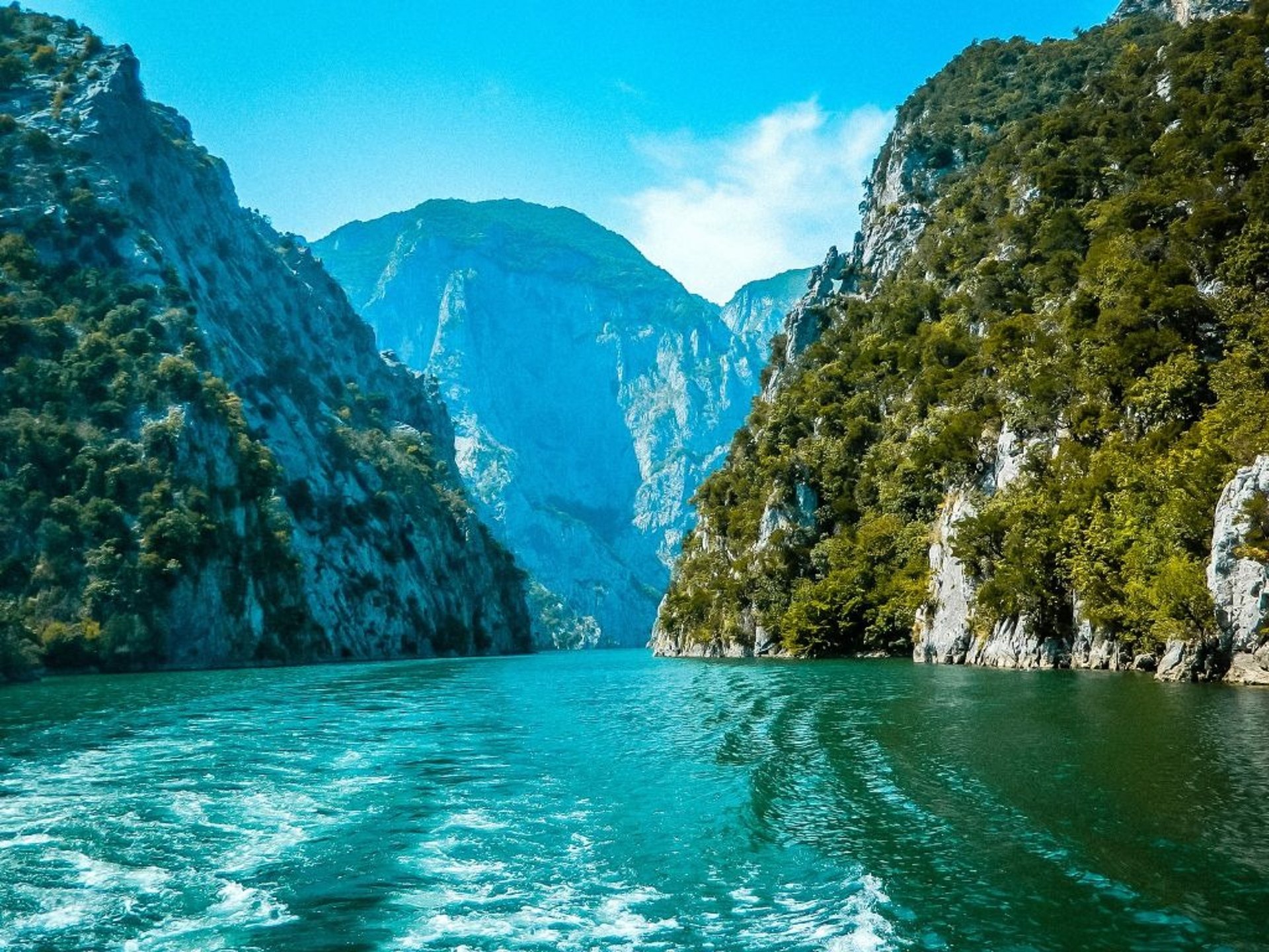 Lake Kolmani surrounded by mountains in Albania