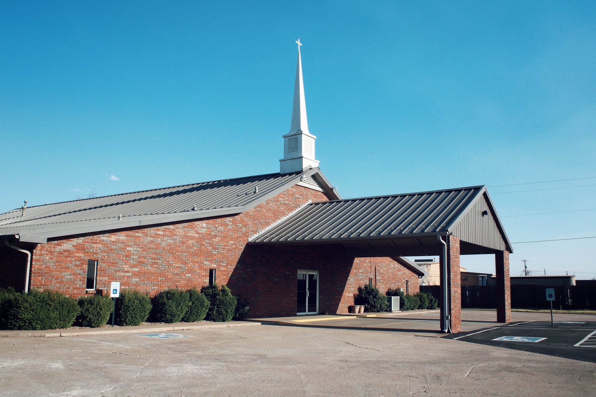 brown chapel surrounded green grass