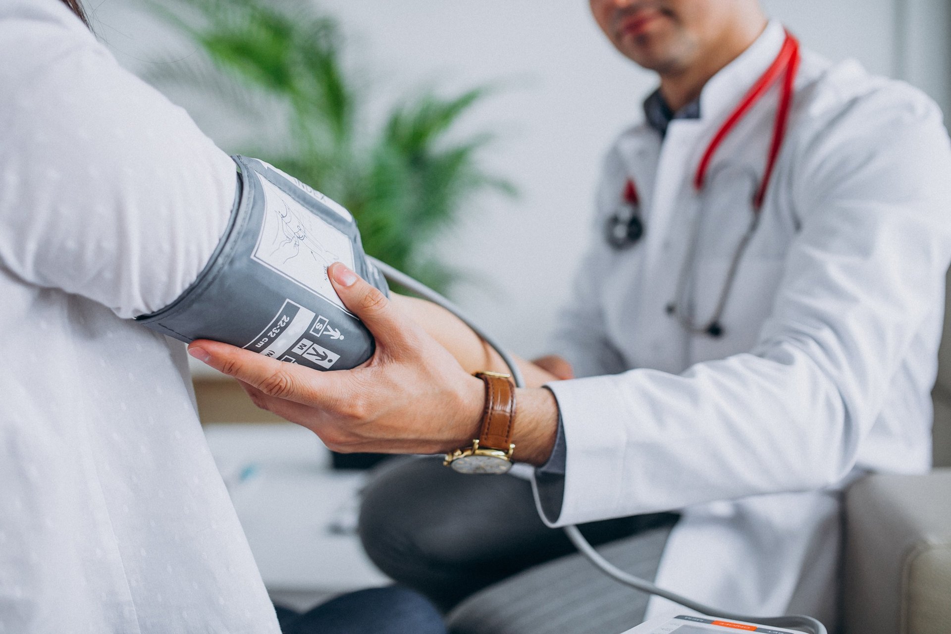 doctor holding red stethoscope