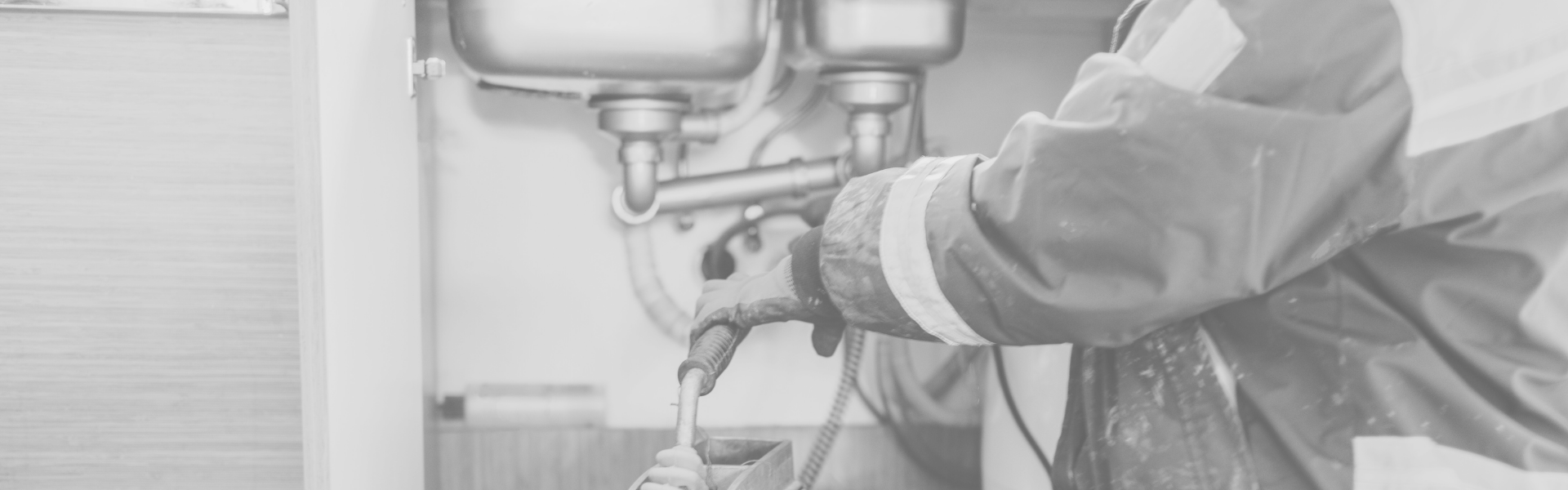 a man working on a pipe in a wall