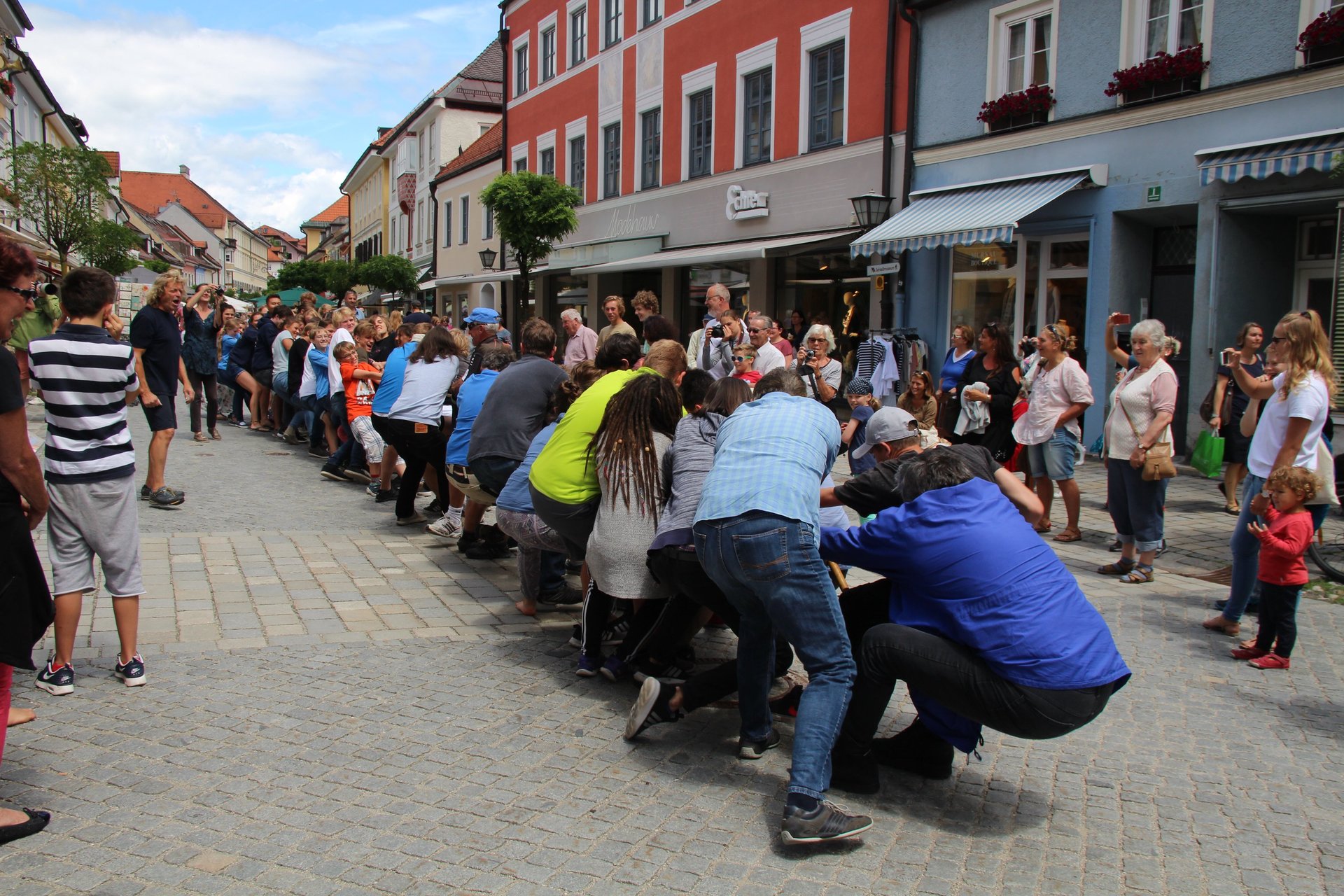 fiver person running on the field near trees