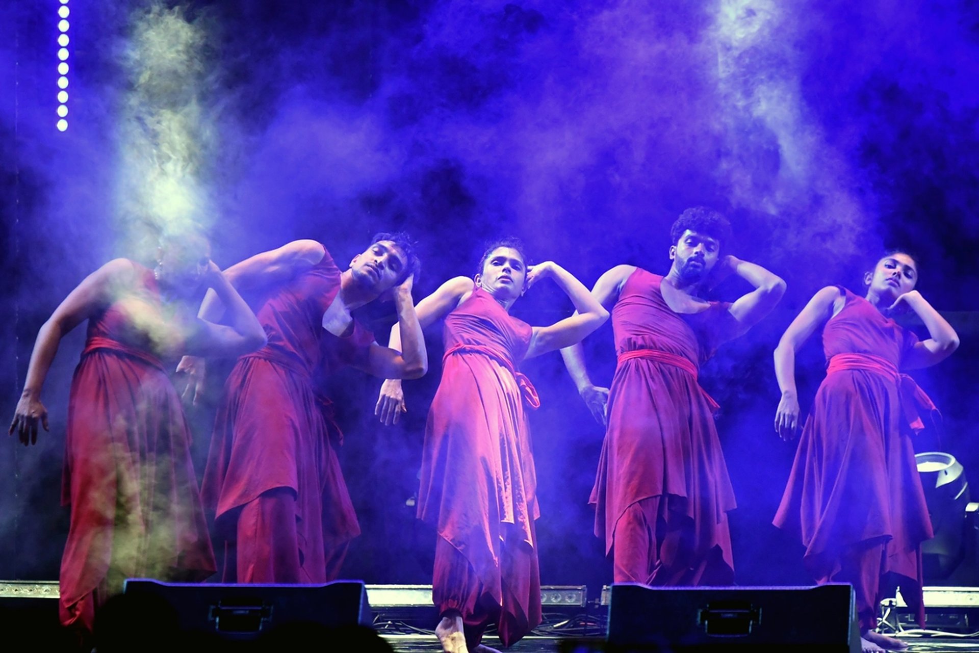 woman wearing yellow long-sleeved dress under white clouds and blue sky during daytime