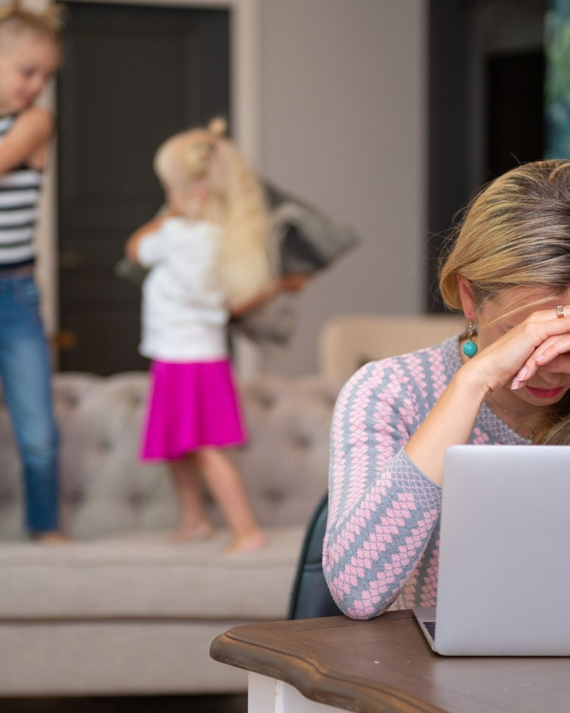 a woman sitting in front of a laptop computer