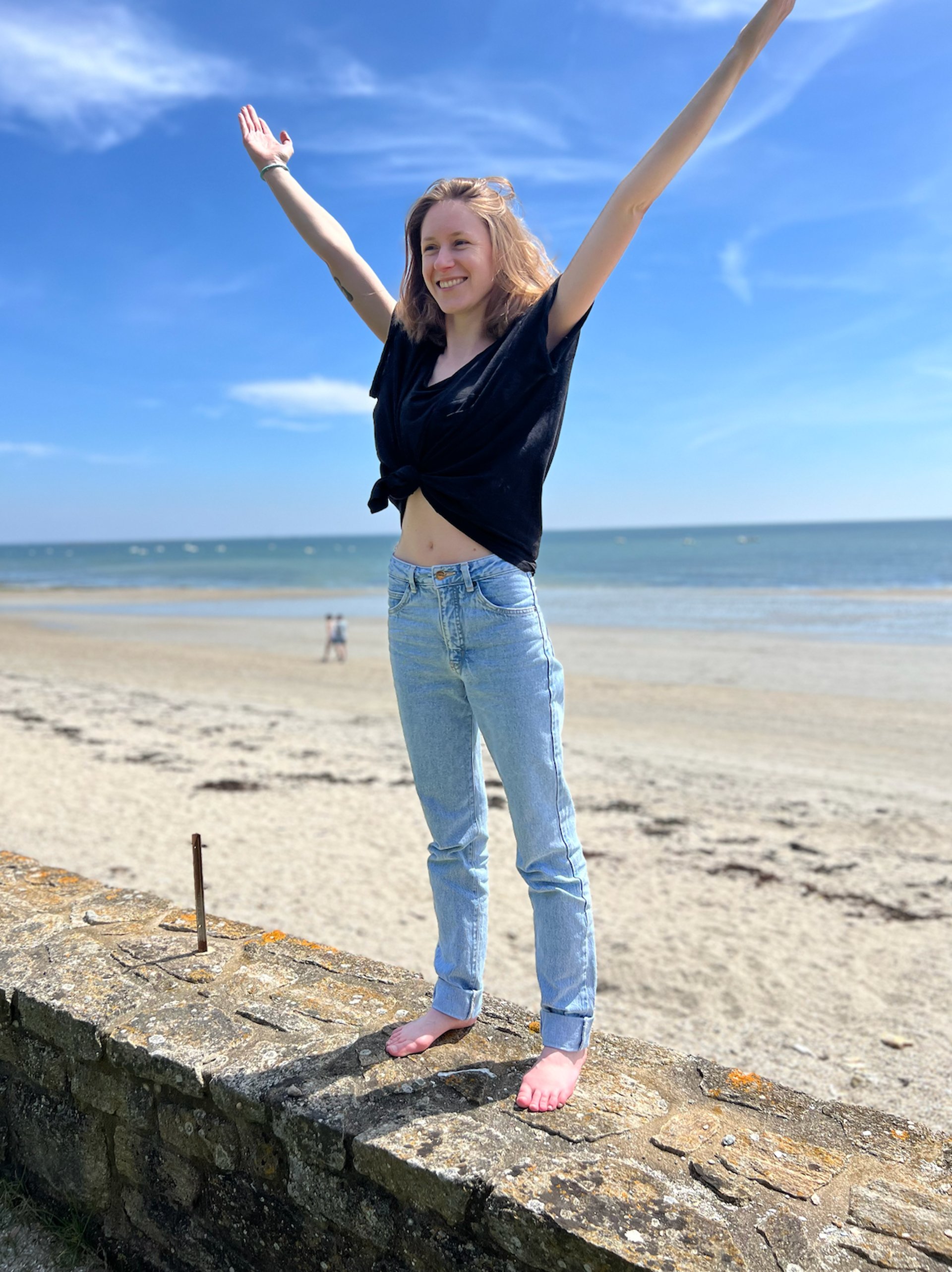 a sandy beach with tracks in the sand