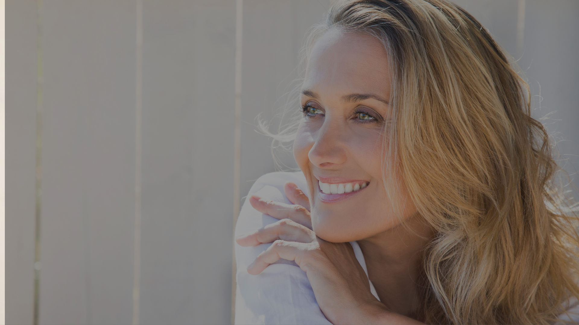 woman in white crew neck shirt smiling