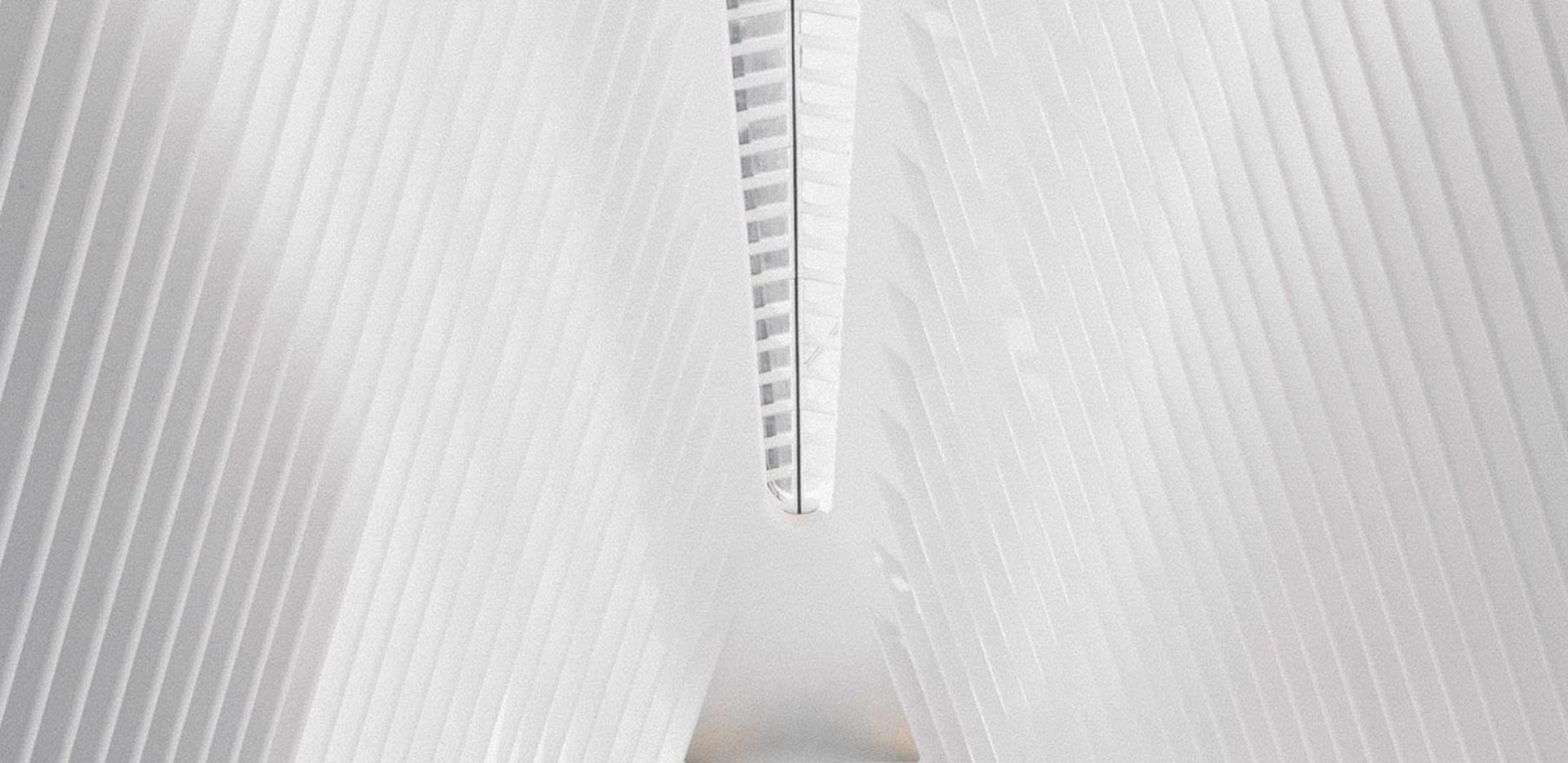 an abstract photo of a curved building with a blue sky in the background