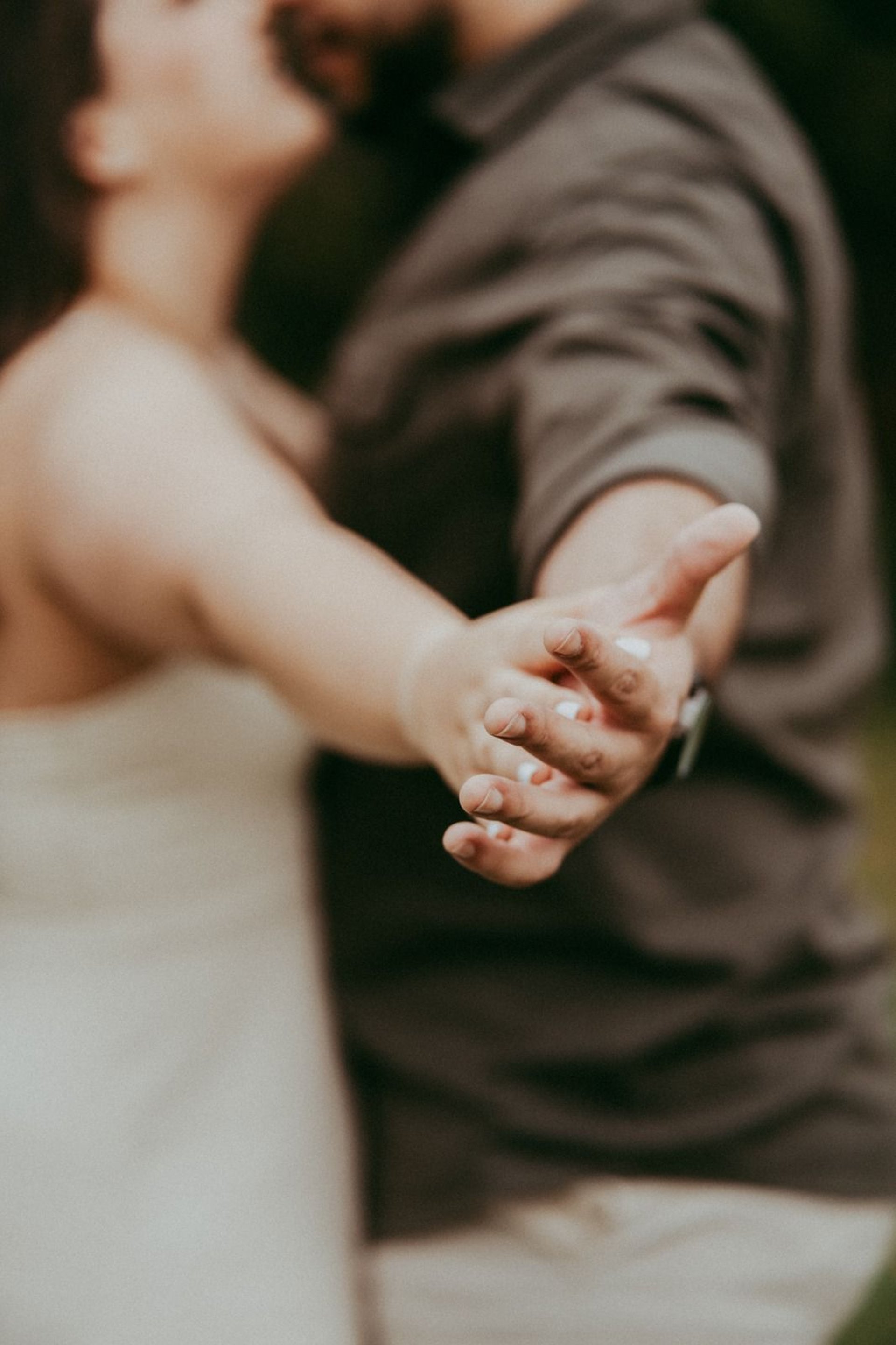 couple wearing silver-colored rings