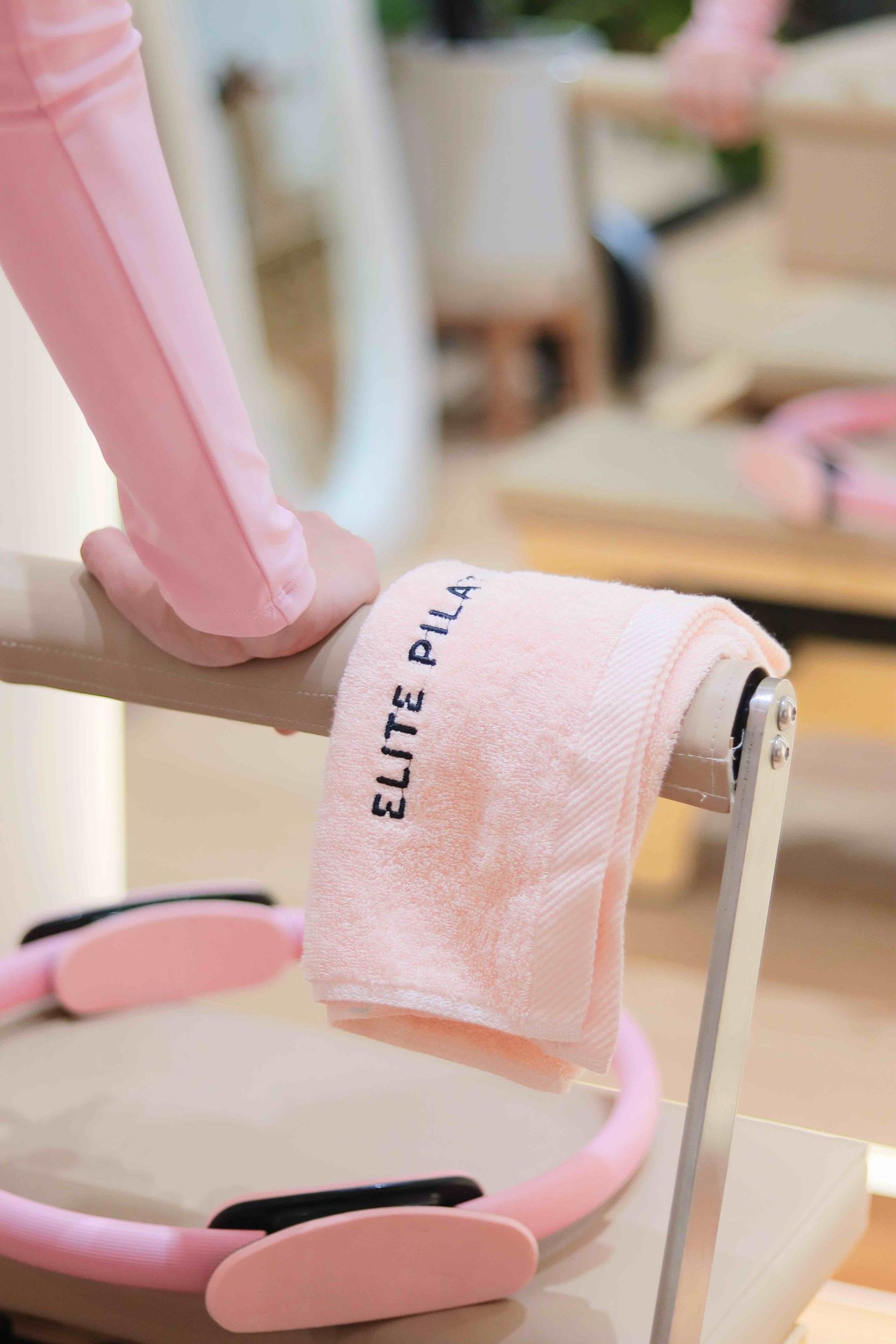 Woman does a pilates exercise on a reformer.