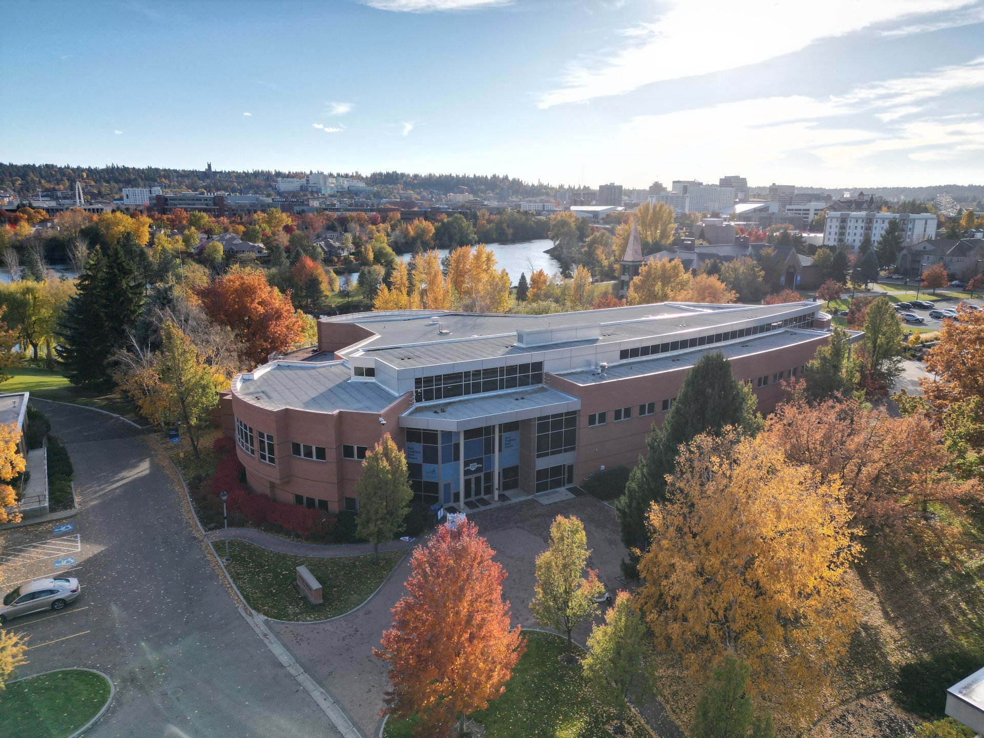 an abstract photo of a curved building with a blue sky in the background