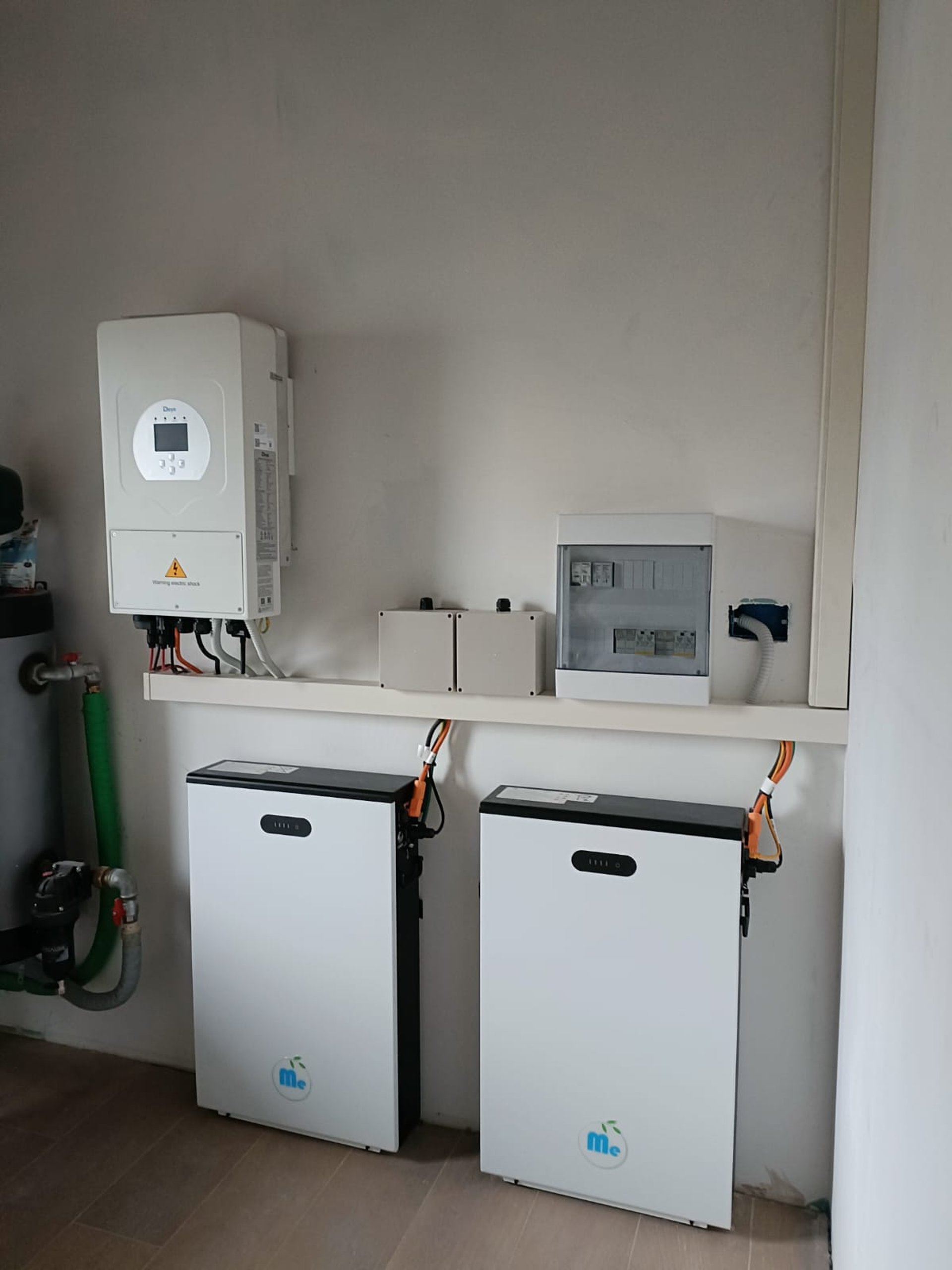 man in orange and black vest wearing white helmet holding yellow and black power tool
