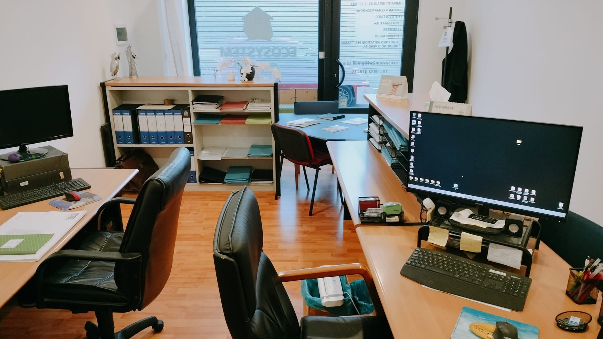 three men sitting on chair beside tables