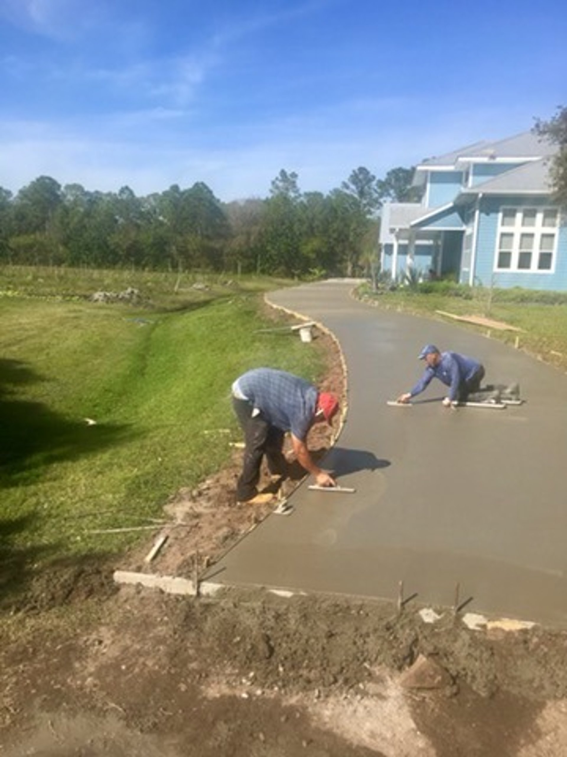 a house with a garage in the middle of a driveway