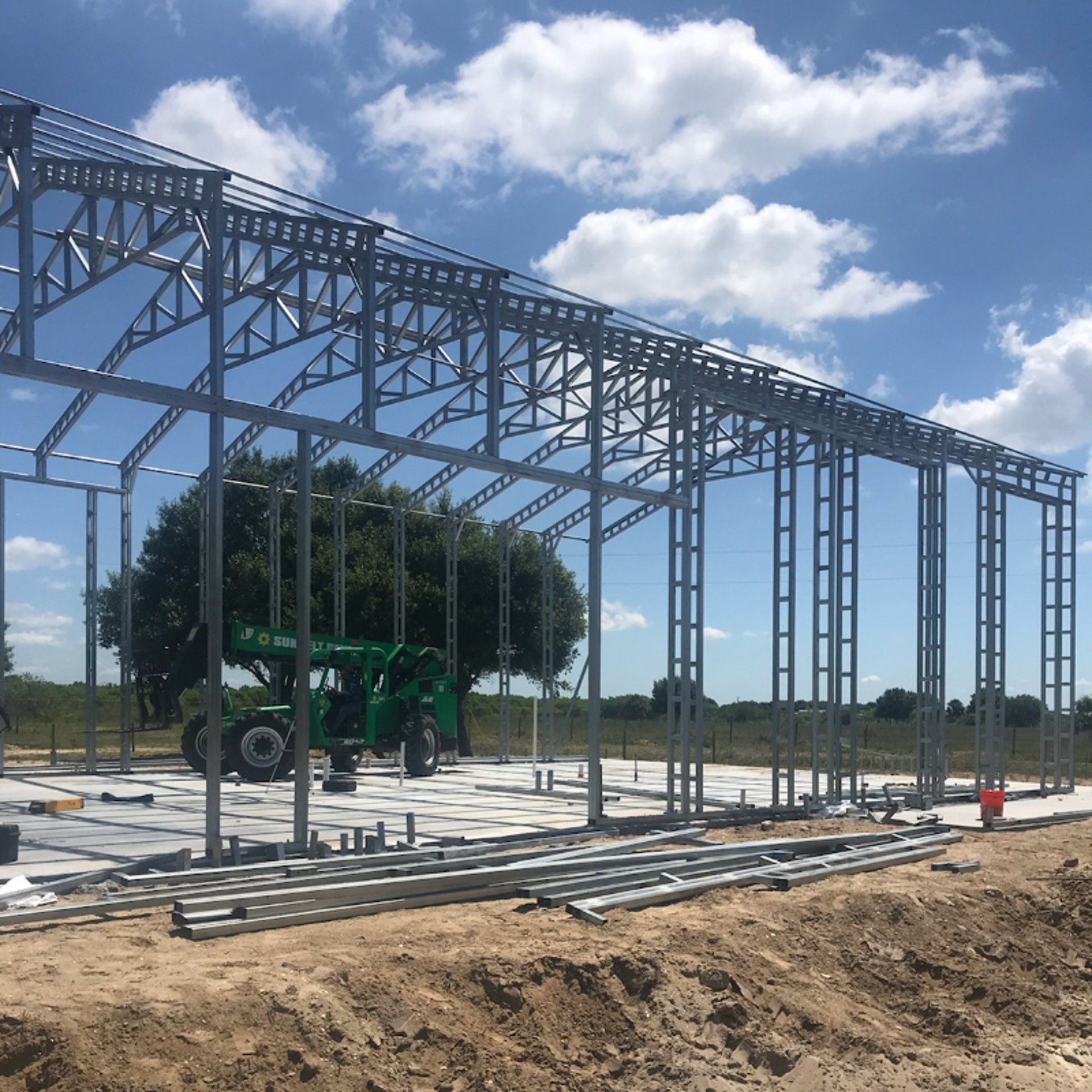 a man standing next to a building under construction