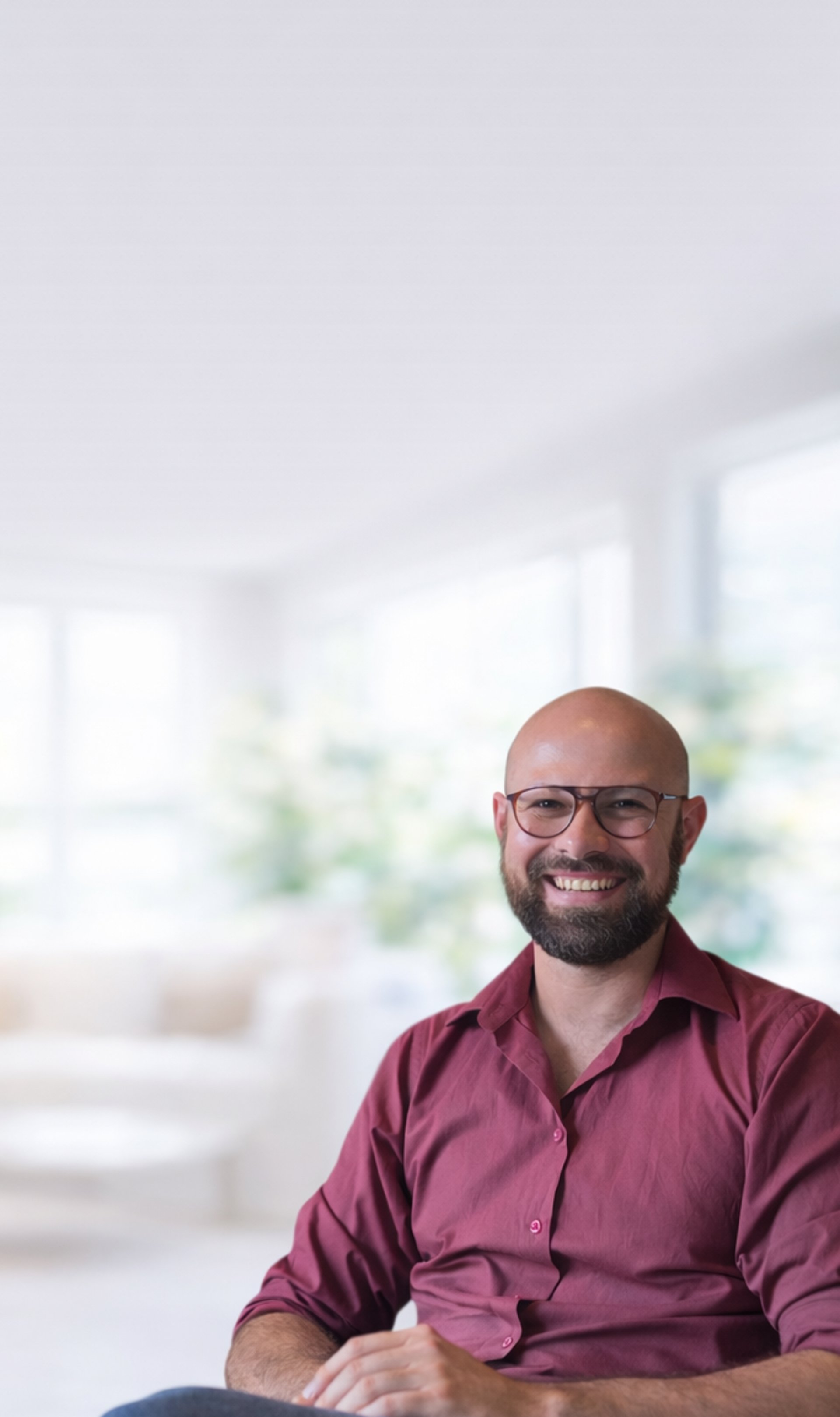 an abstract photo of a curved building with a blue sky in the background