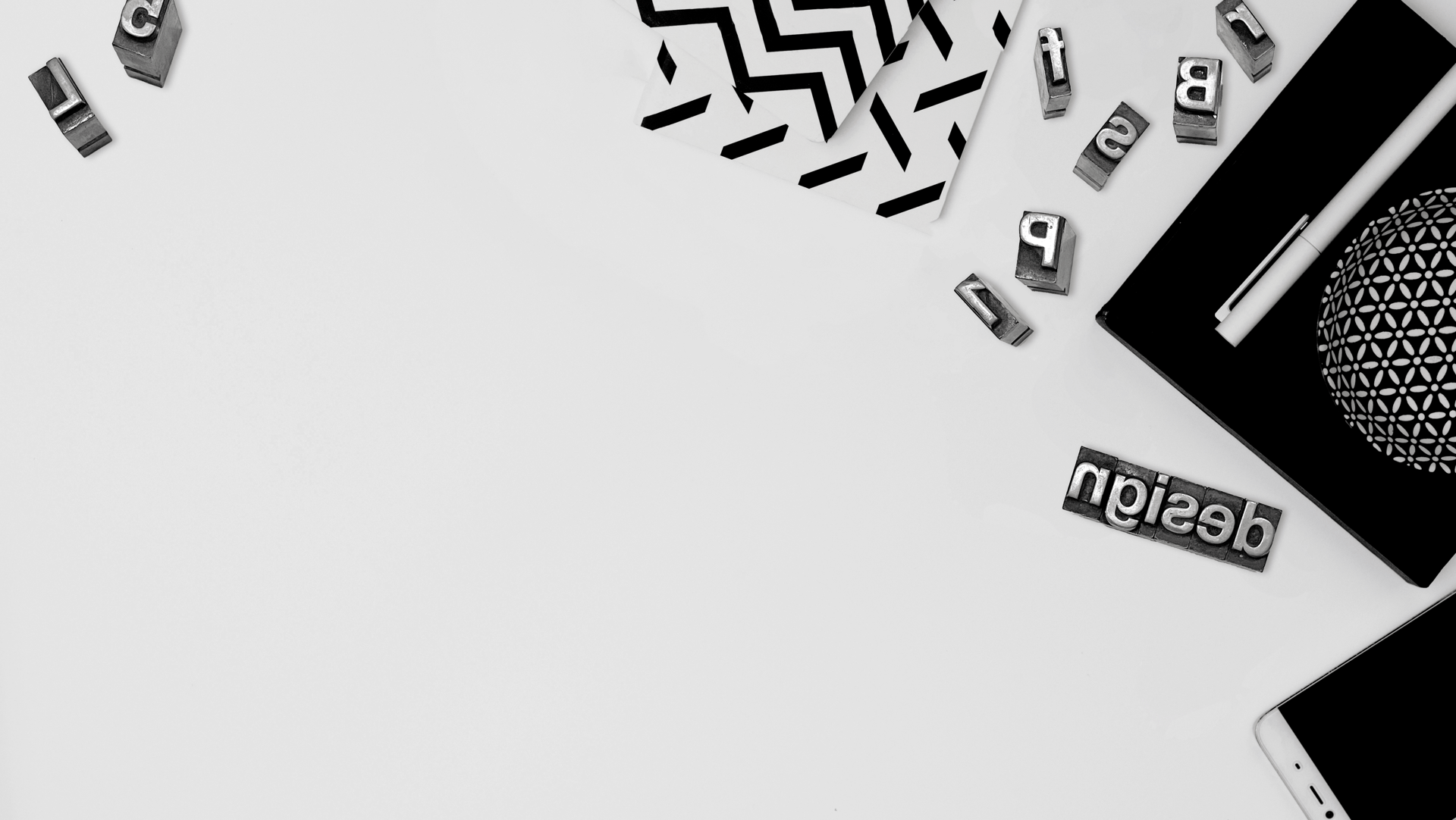 three white paper clips, black ceramic mug, black pencil, and white pencil eraser on white surface