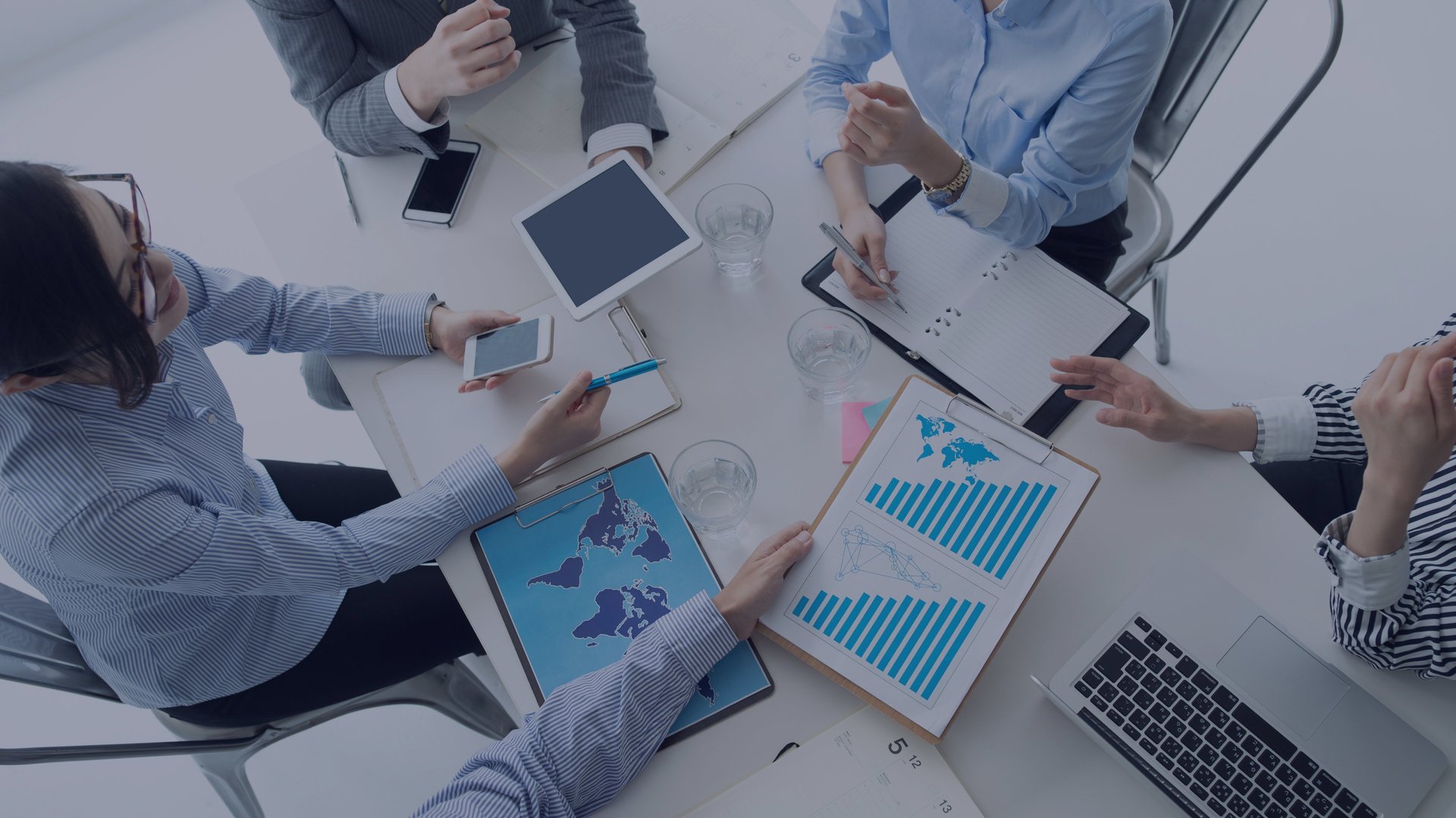 man standing in front of people sitting beside table with laptop computers