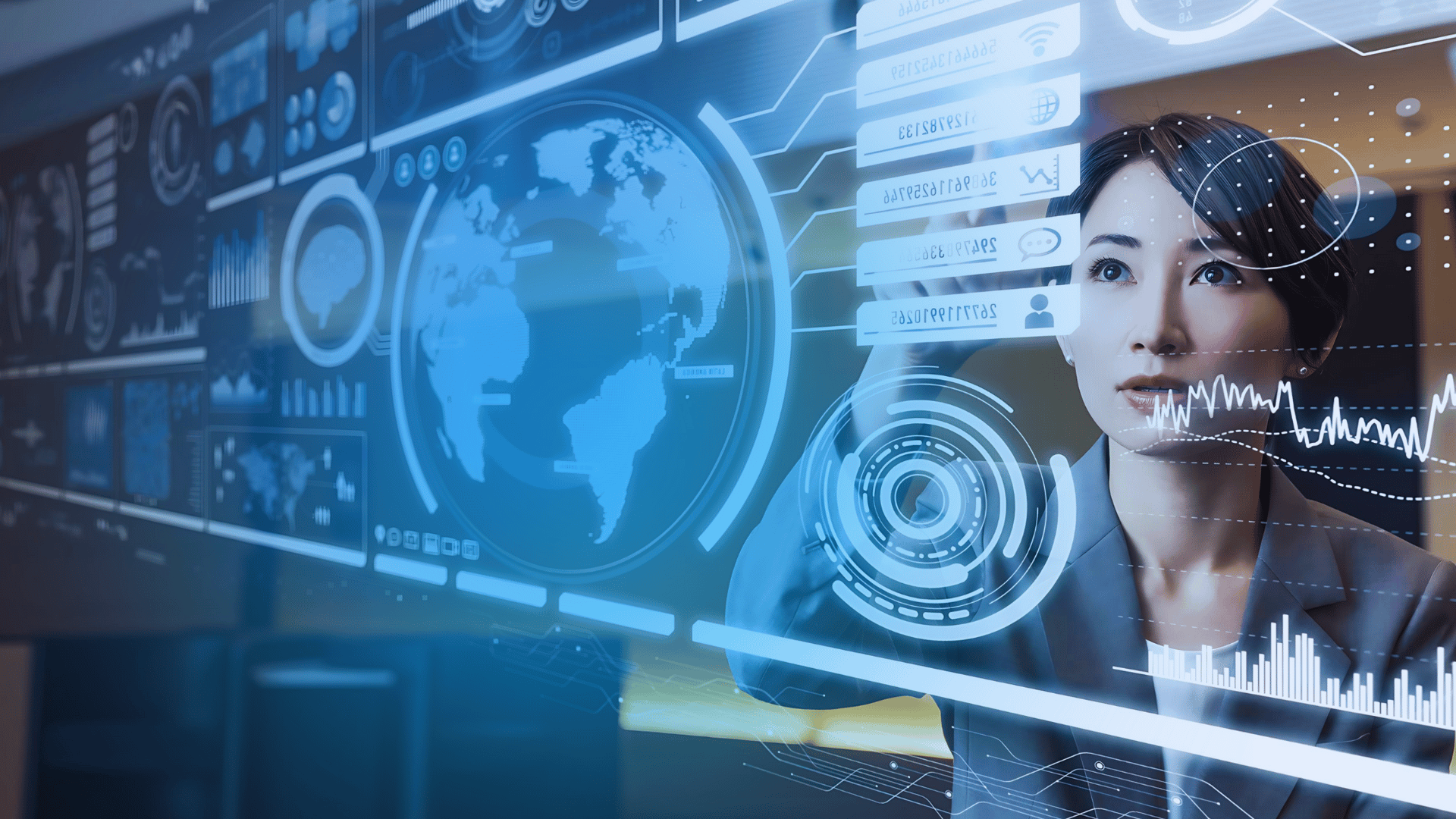 Female business leader in a suit reviewing data on a touchscreen glass wall
