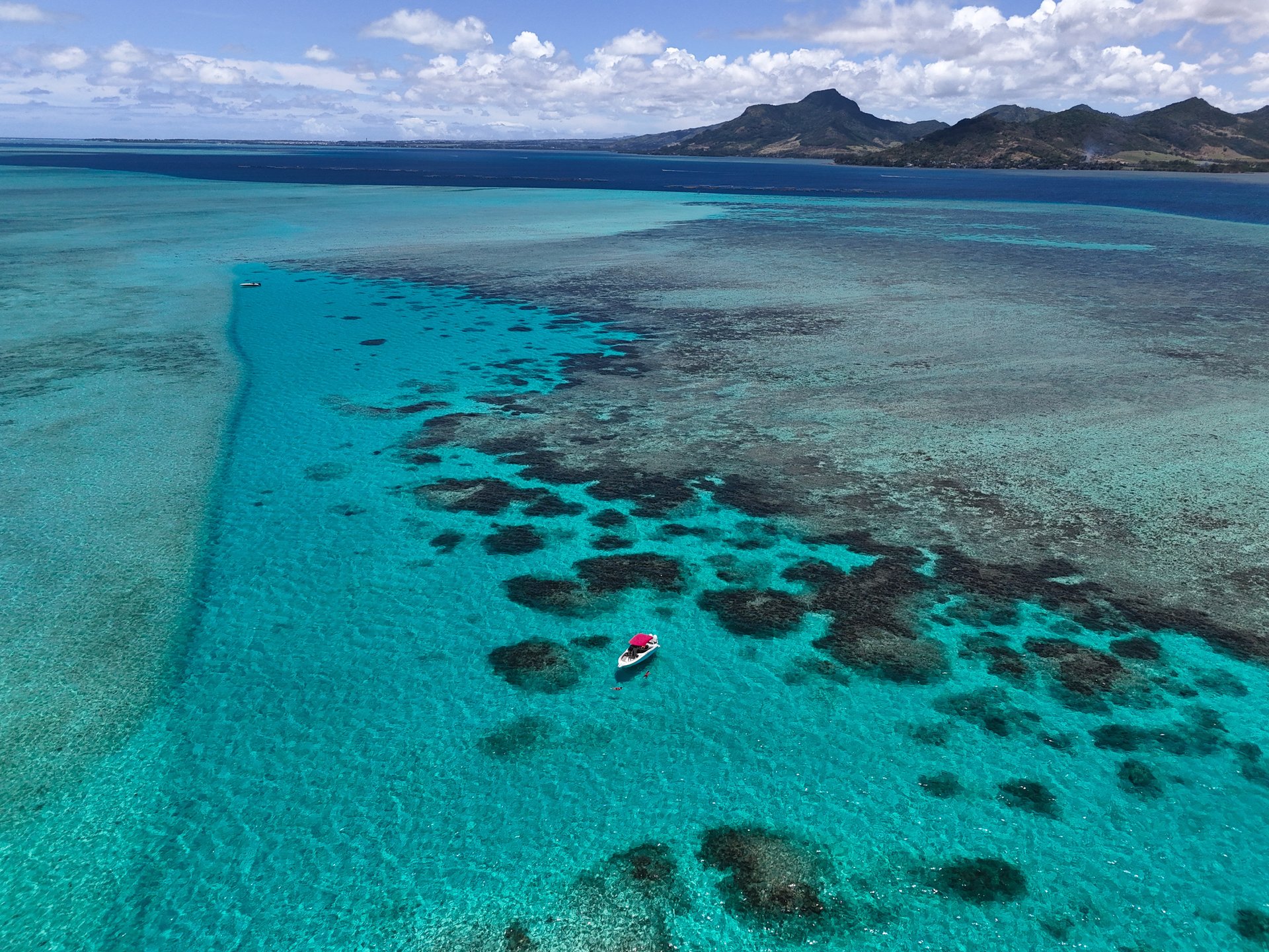 a group of boats floating on top of a body of water