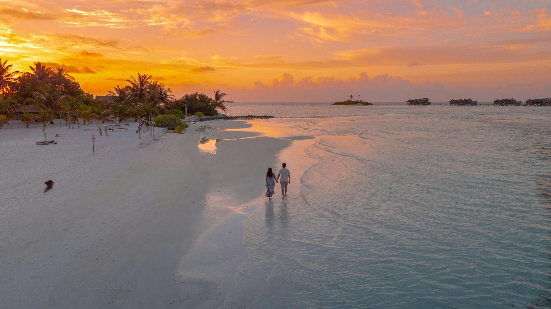 man kneeling in front of a woman by the beach during golden hour