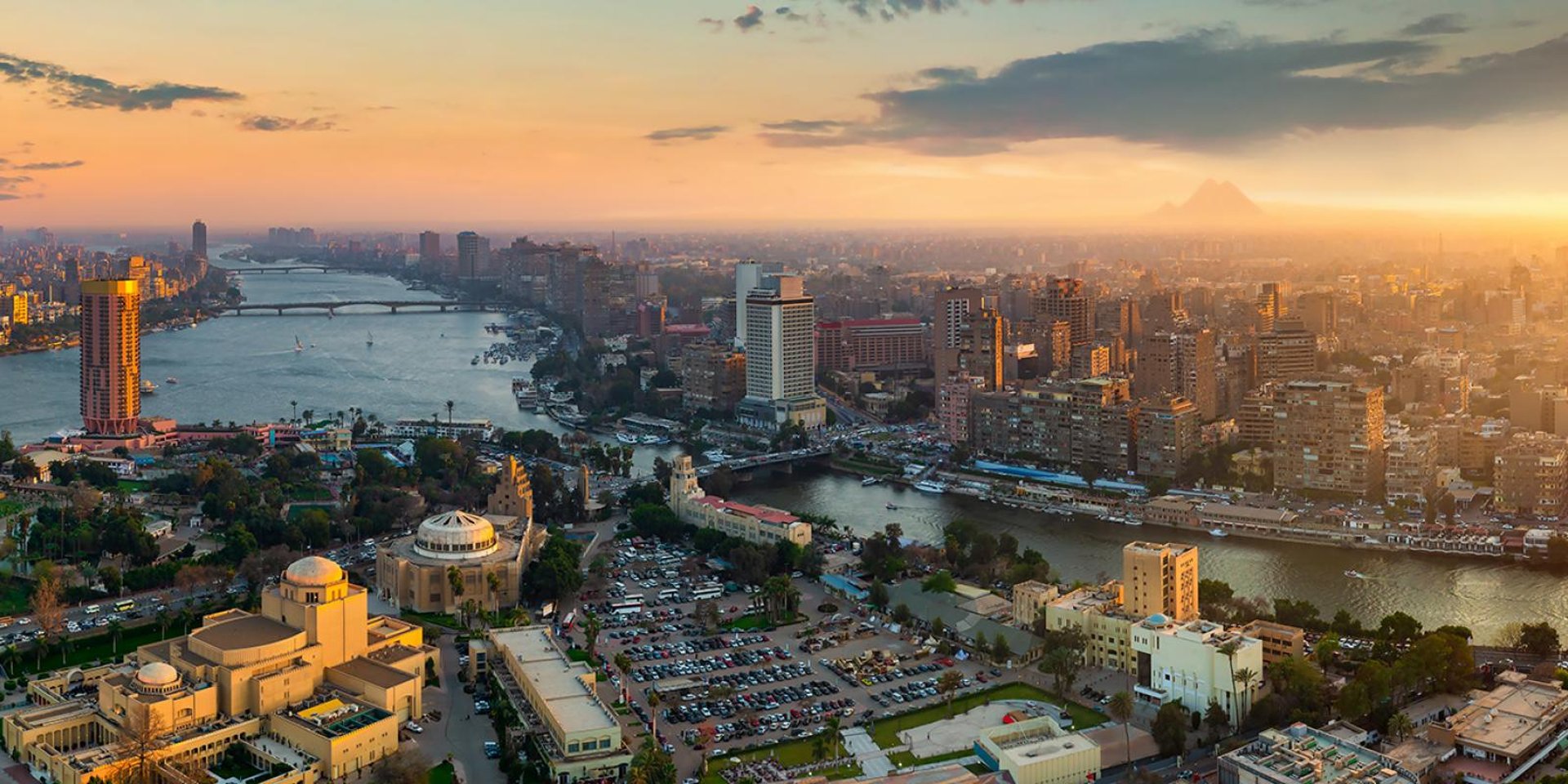 woman wearing yellow long-sleeved dress under white clouds and blue sky during daytime
