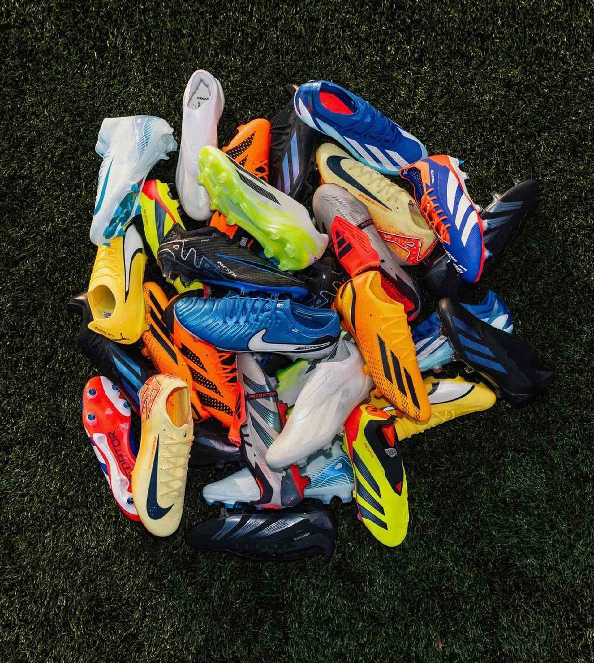 a pair of black and gold shoes on a black surface