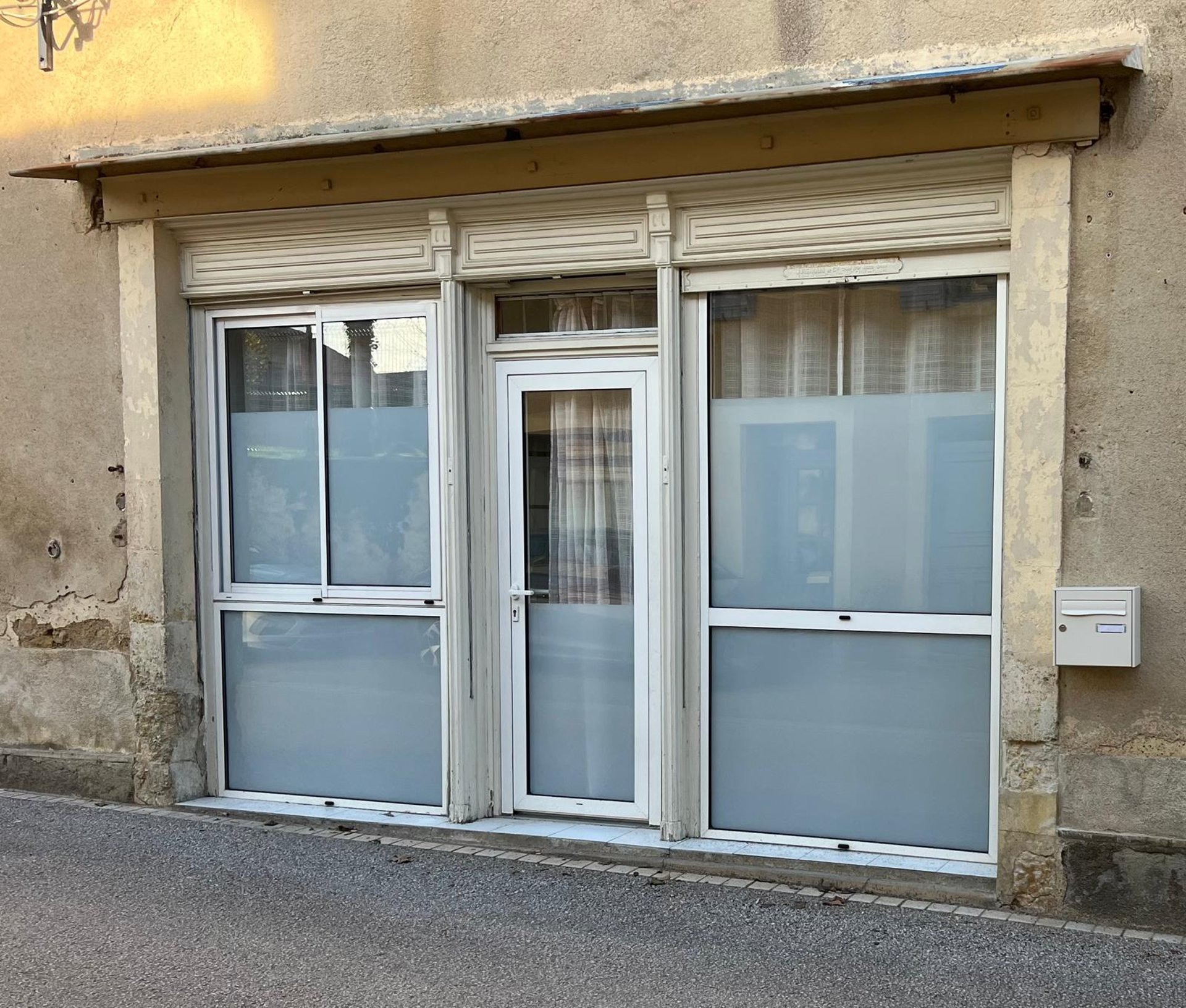 a room with a glass door that has a plant in it