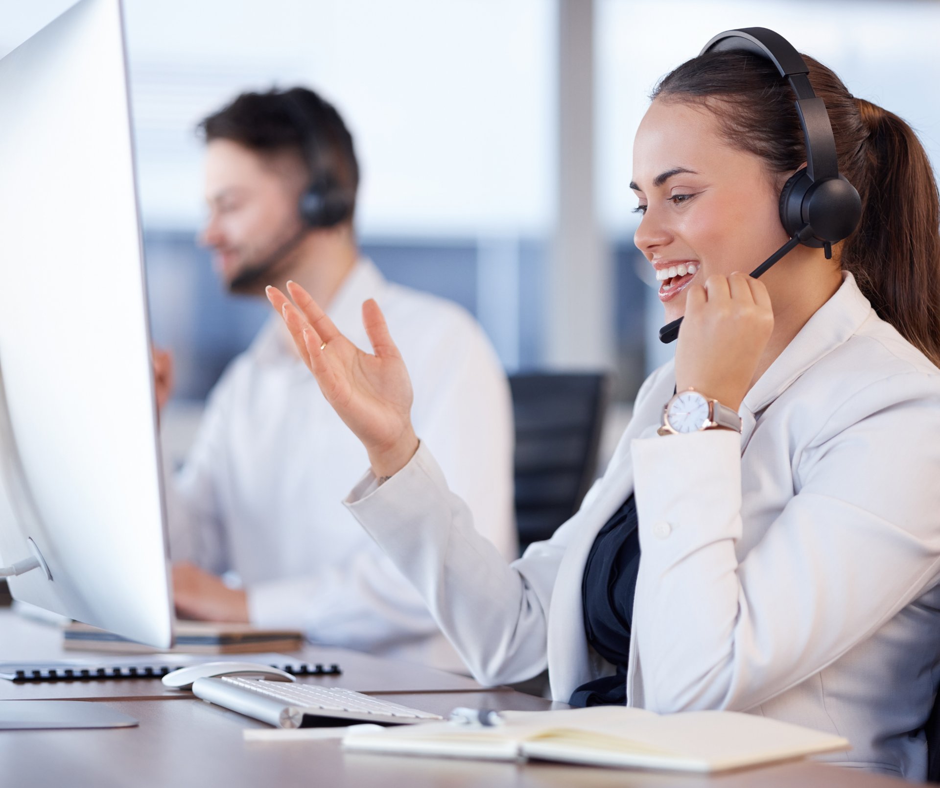 woman in black headphones holding black and silver headphones