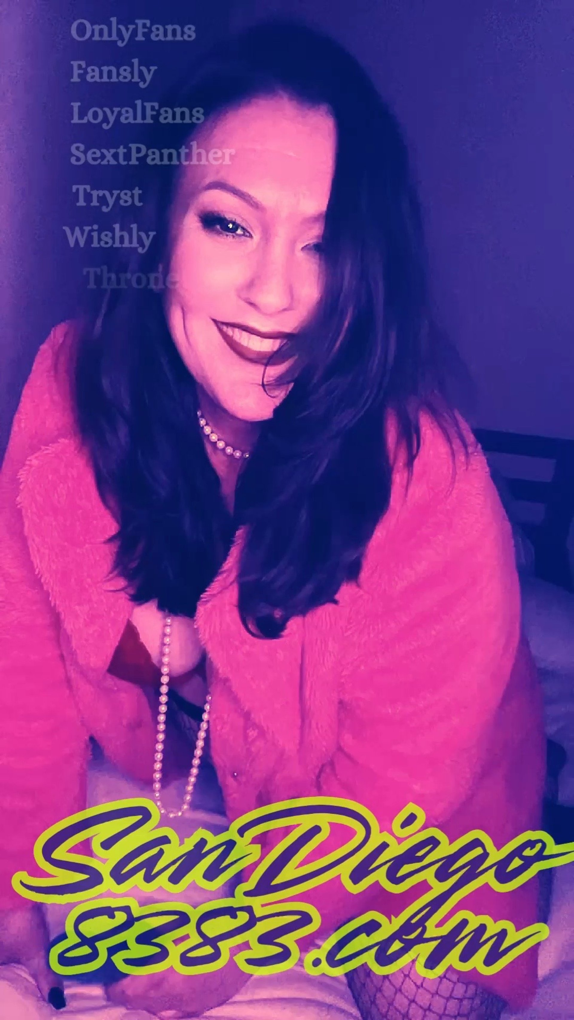 SanDiego8383 wears a bright pink coat; smiles seductively and holds a blue vibrator