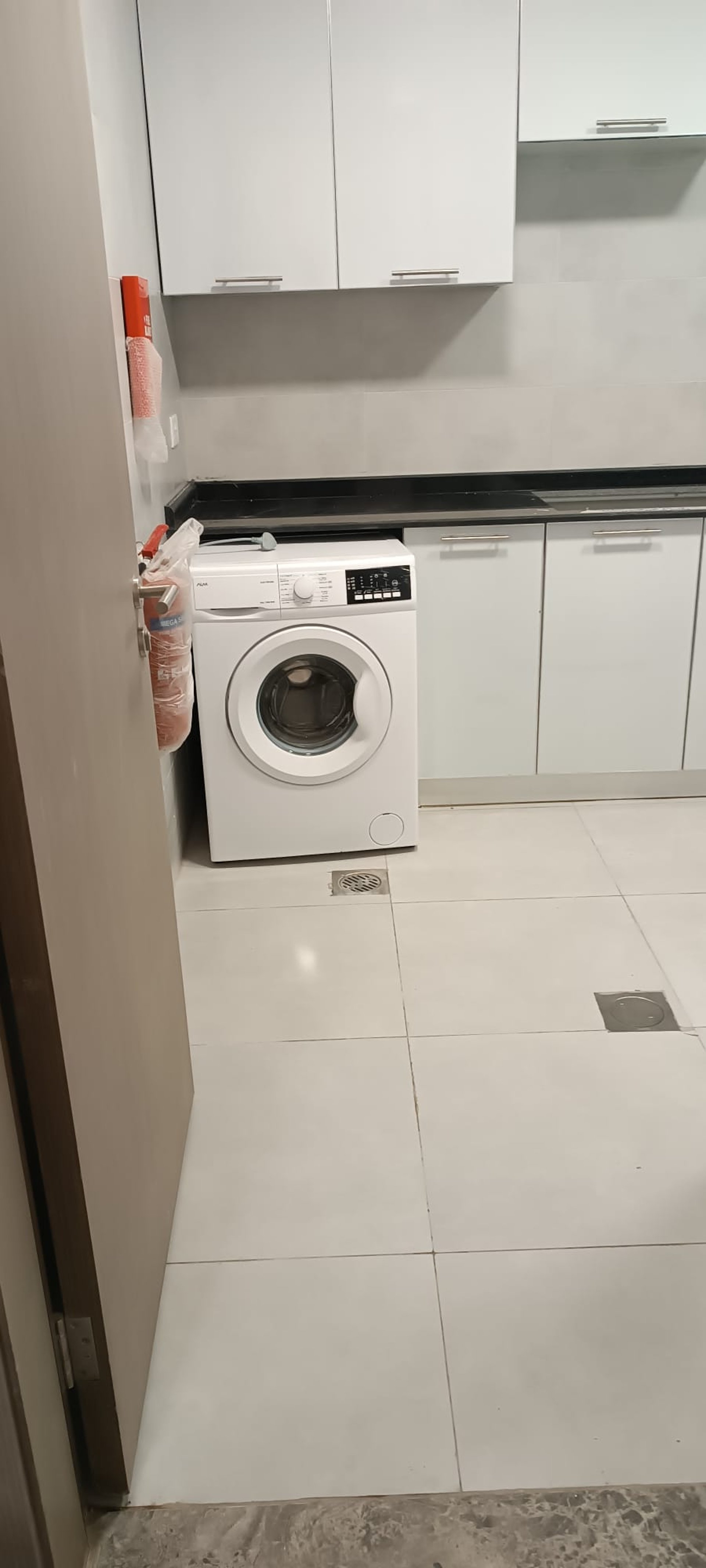 kitchen with white cabinet and washing machine