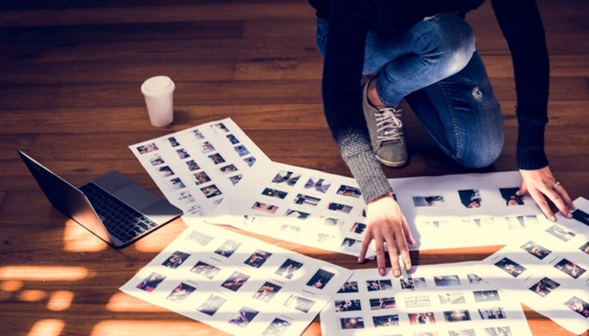 person typing on MacBook Pro on brown wooden table during daytime photo
