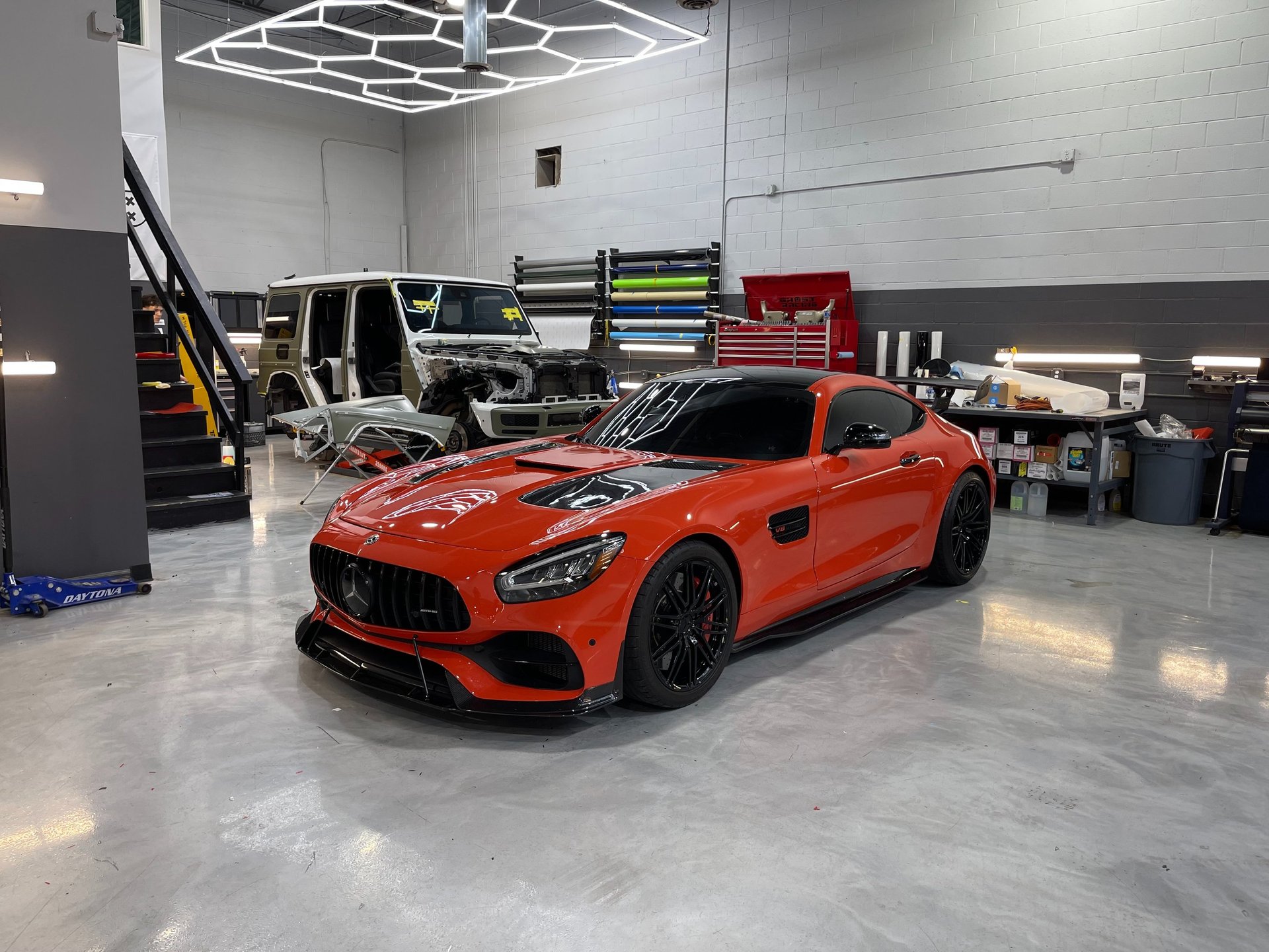 A couple of cars are parked in a garage
