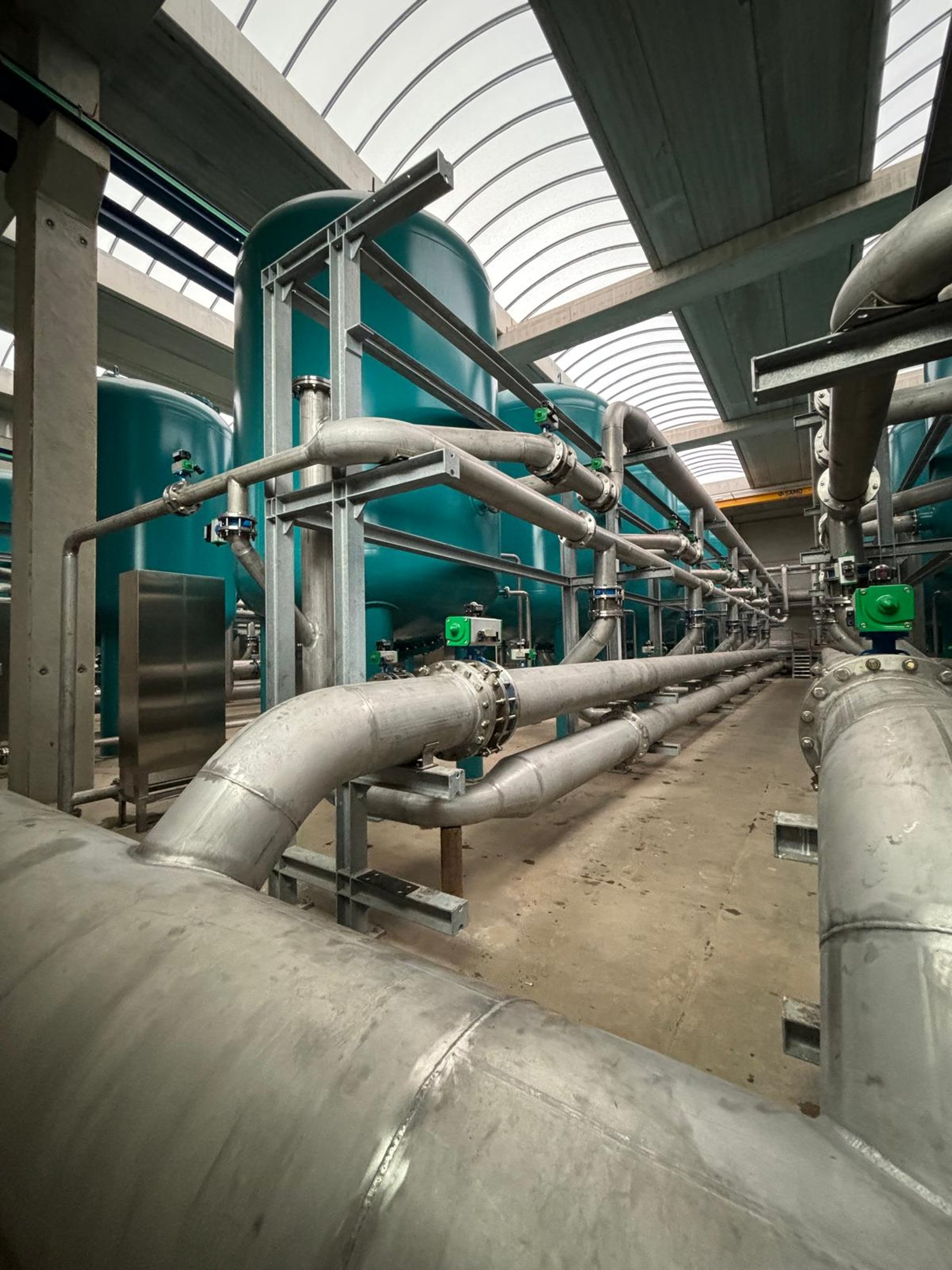 an abstract photo of a curved building with a blue sky in the background