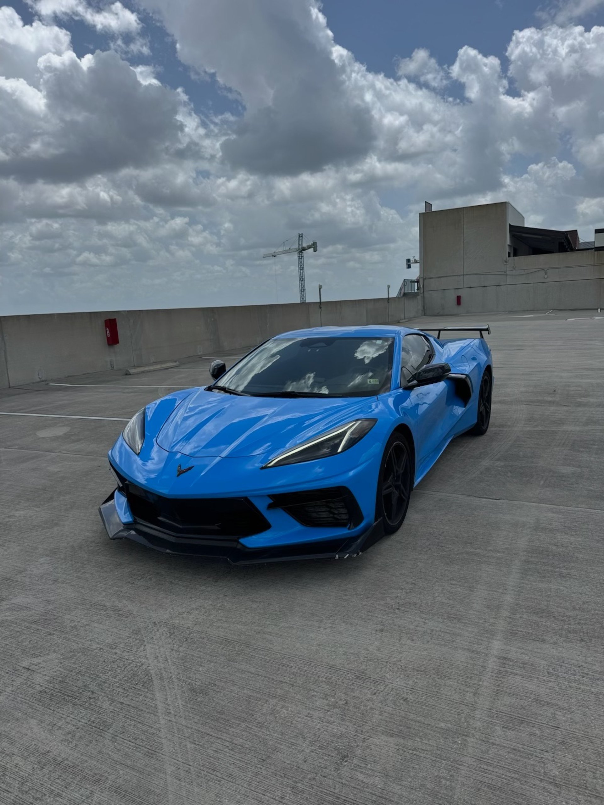 a white sports car parked on the side of the road