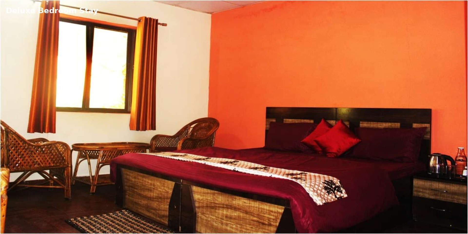 Deluxe bedroom at Jungle Lore Resort with comfortable bed and cozy interior
